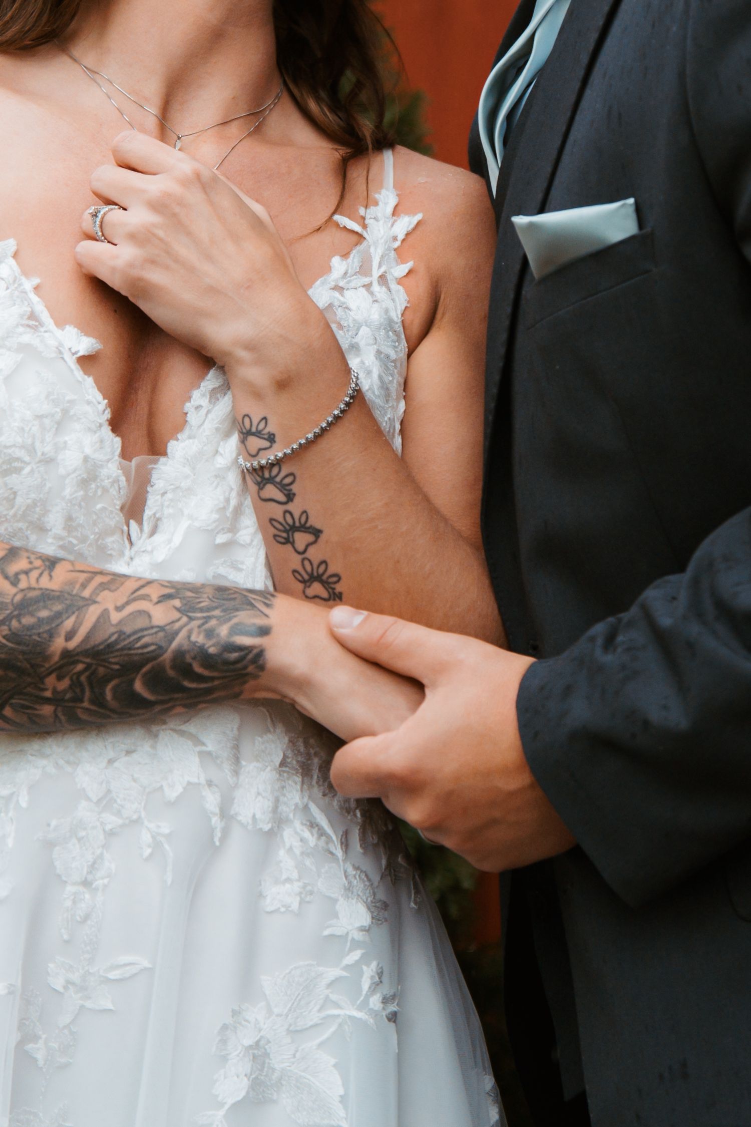 Close-up shots of tattooed arms embracing in formal wedding attire. Delta, Ohio wedding venue