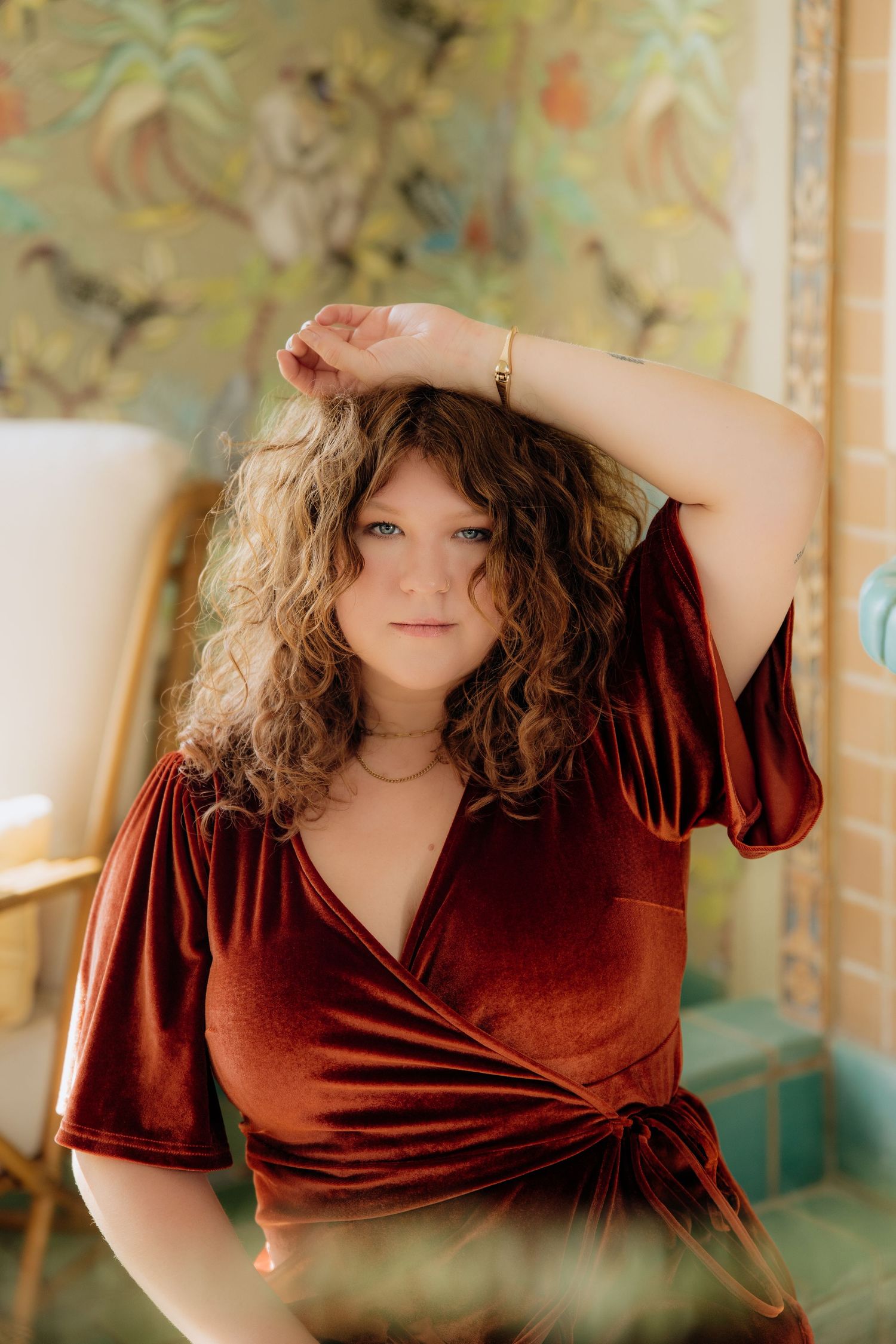 Portrait session featuring burgundy velvet dress against floral wallpaper backdrop. The christy house, fremont, ohio