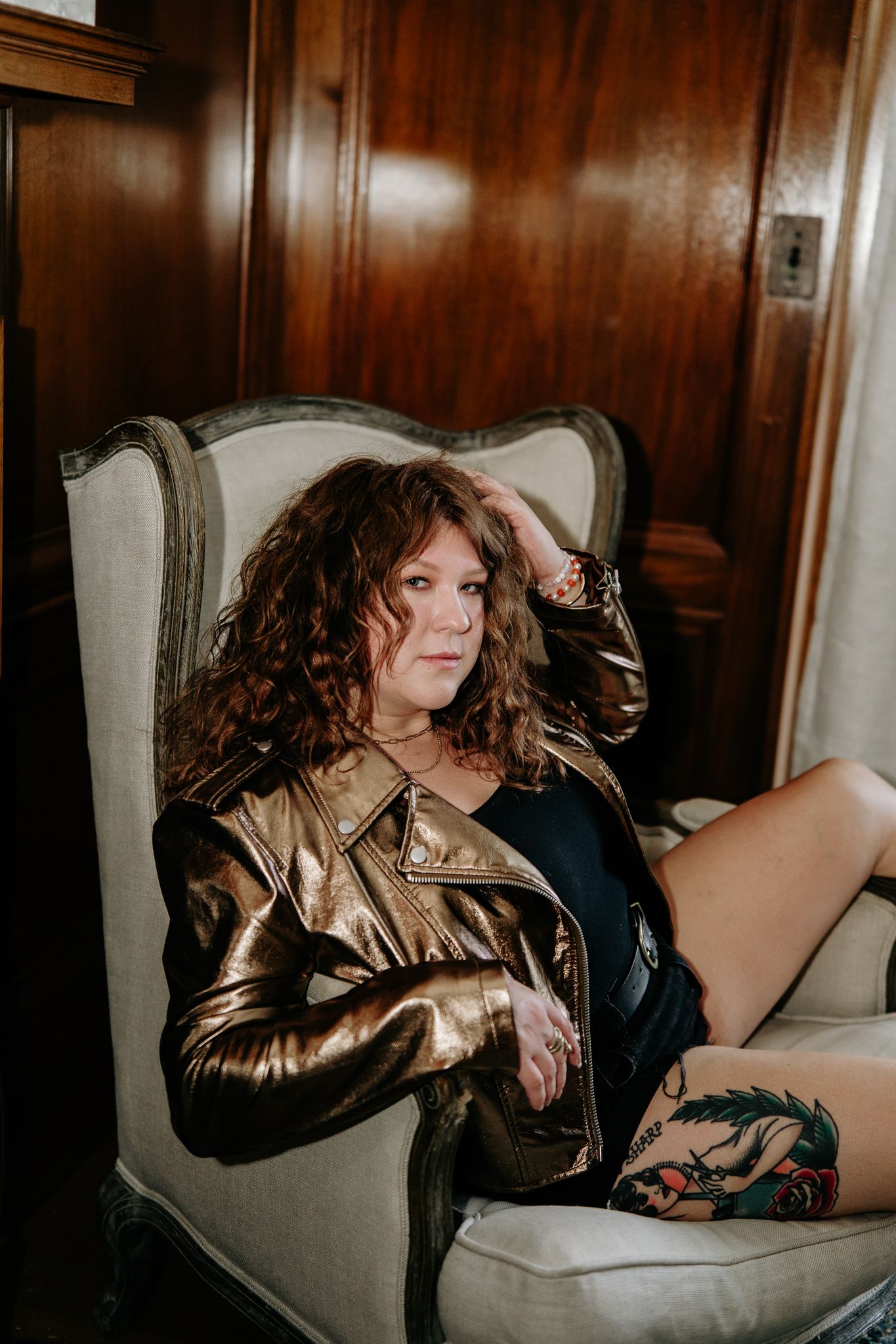 Editorial style photos in a vintage chair wearing a metallic leather jacket. The christy house, fremont, ohio