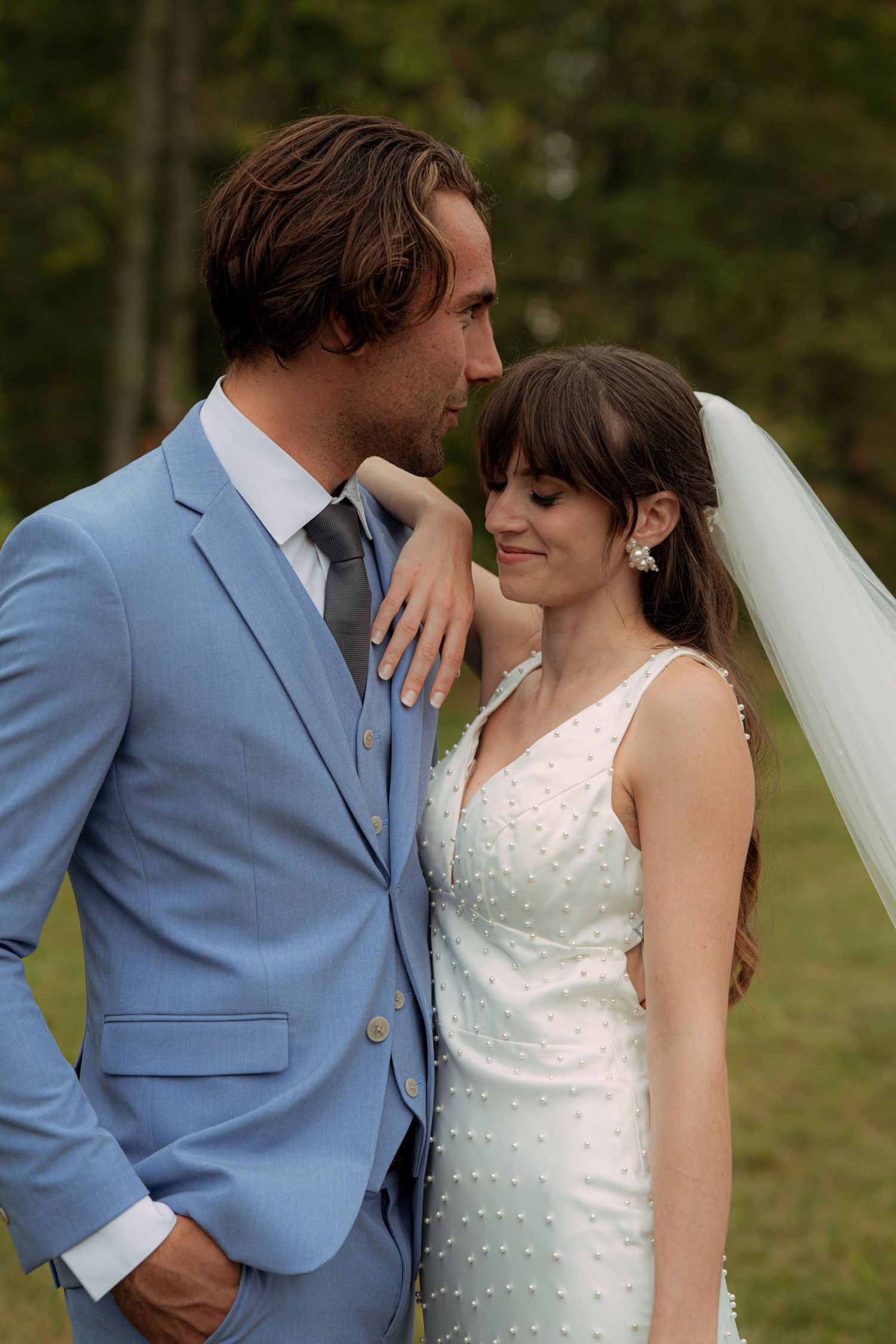 Romantic wedding couple portrait with groom in blue suit and bride in white dress. Wooster Ohio The Wellspring Wedding Venue