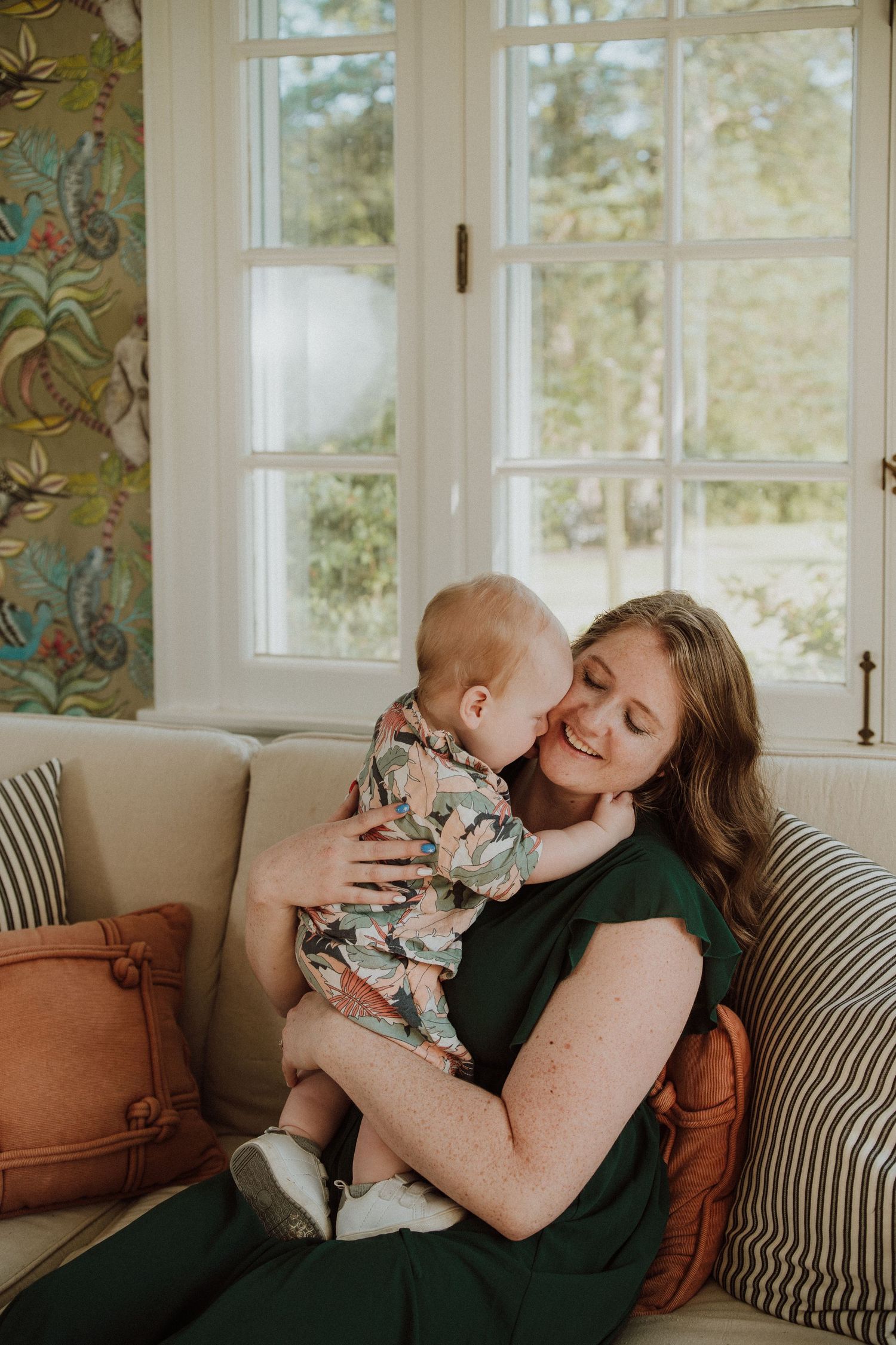 Tender moment shared in a sunlit room with white windows and cozy furniture. The christy house, fremont, ohio