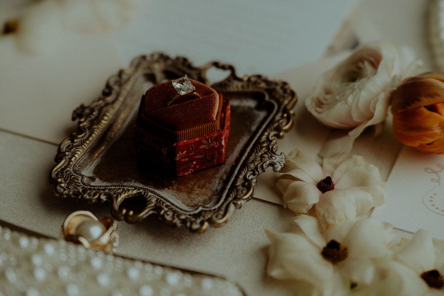Vintage-style ornate frames and wedding details arranged in a soft, dreamy composition. Wooster Ohio The Wellspring Wedding Venue