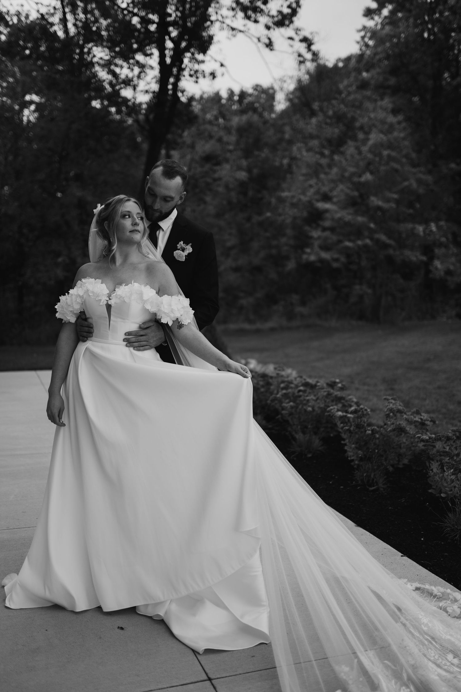 A dramatic black and white wedding dress photo sequence with flowing train. Wooster Ohio The Wellspring Wedding Venue