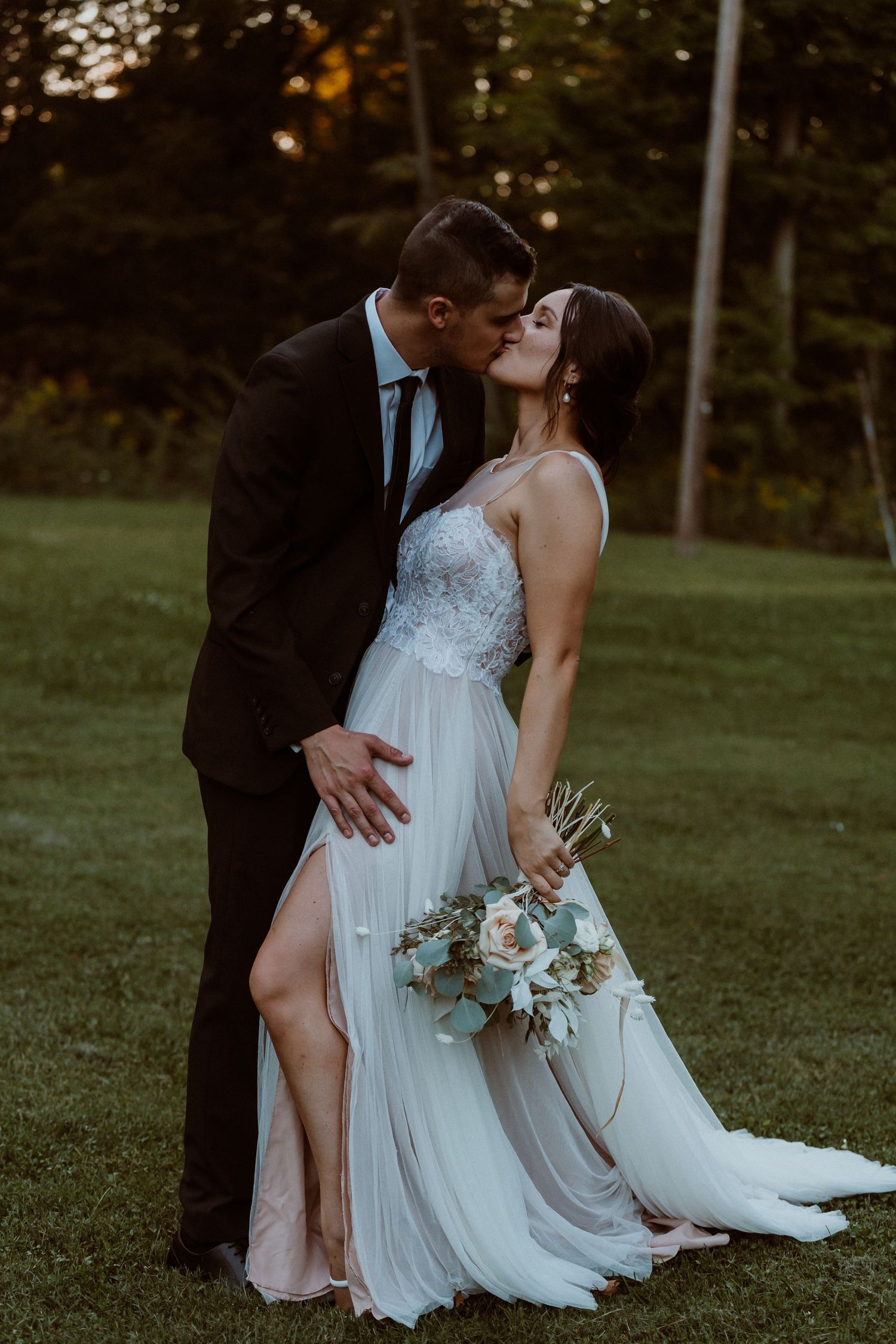 Romantic wedding couple embracing on a grassy lawn at sunset. Hayes Presidential Center Fremont OHIO