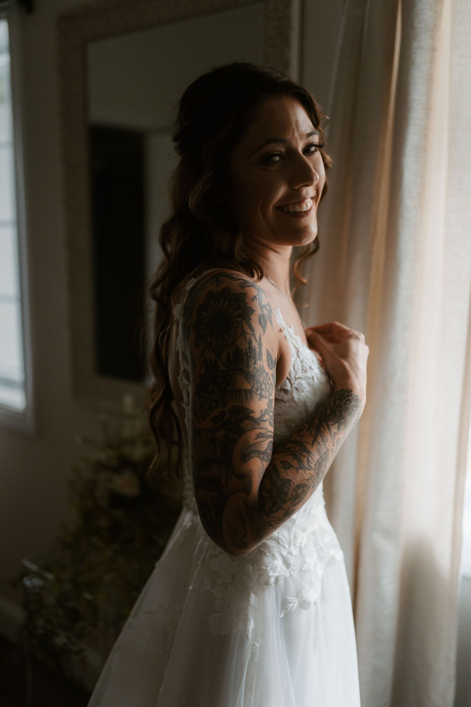 A sequence of moody bridal portraits showing a white wedding dress against window light. Delta, Ohio wedding venue