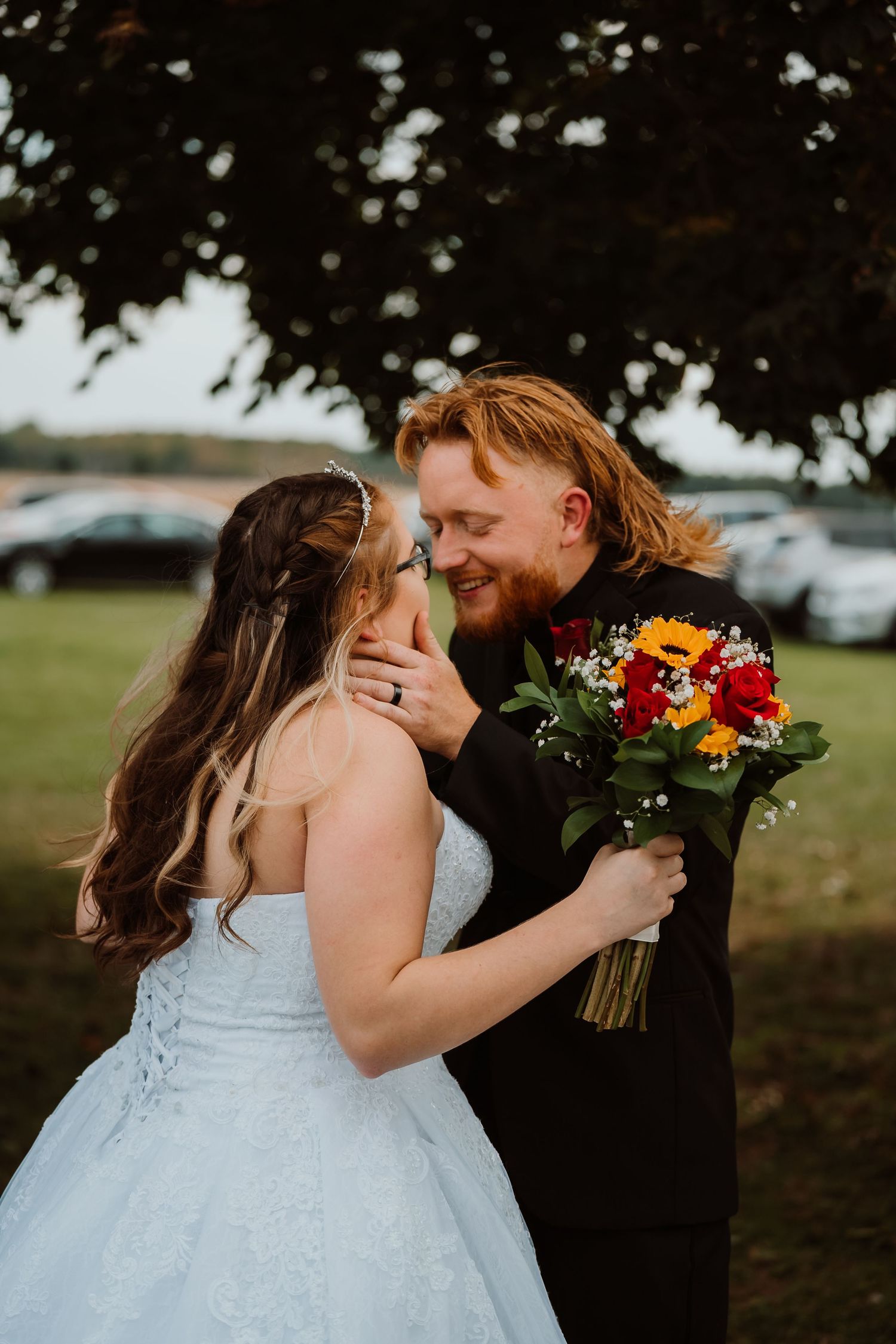 Romantic wedding portrait with couple embracing against natural outdoor backdrop. Tiffin, Ohio Wedding Venue