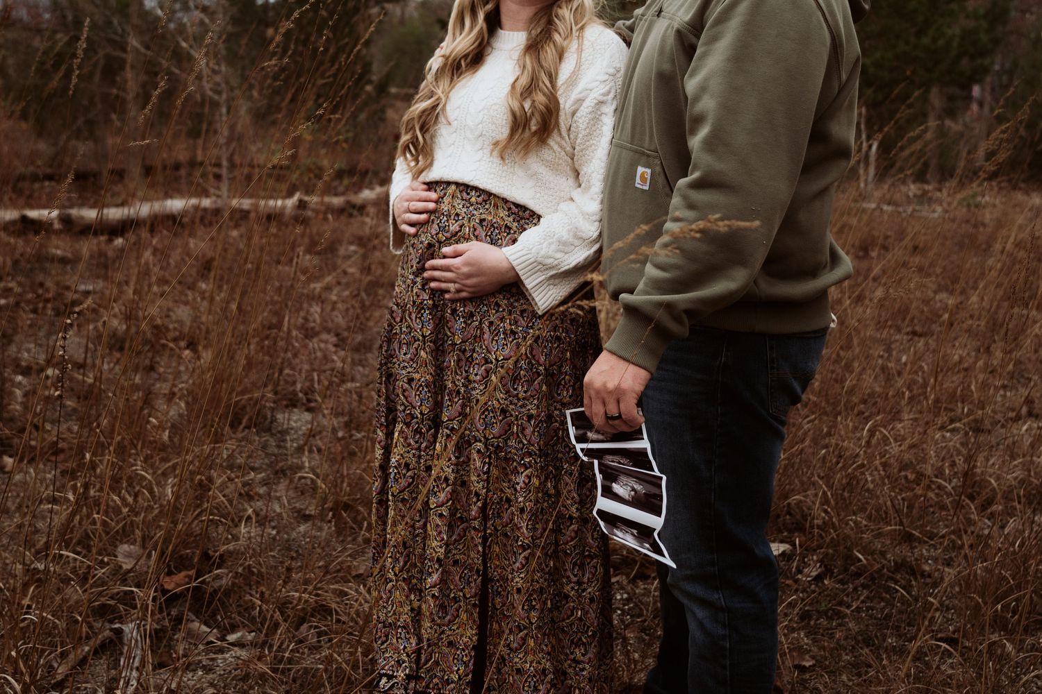 A romantic outdoor photoshoot showing two people embracing in a natural setting with muted brown tones. Castalia Quarry, Ohio