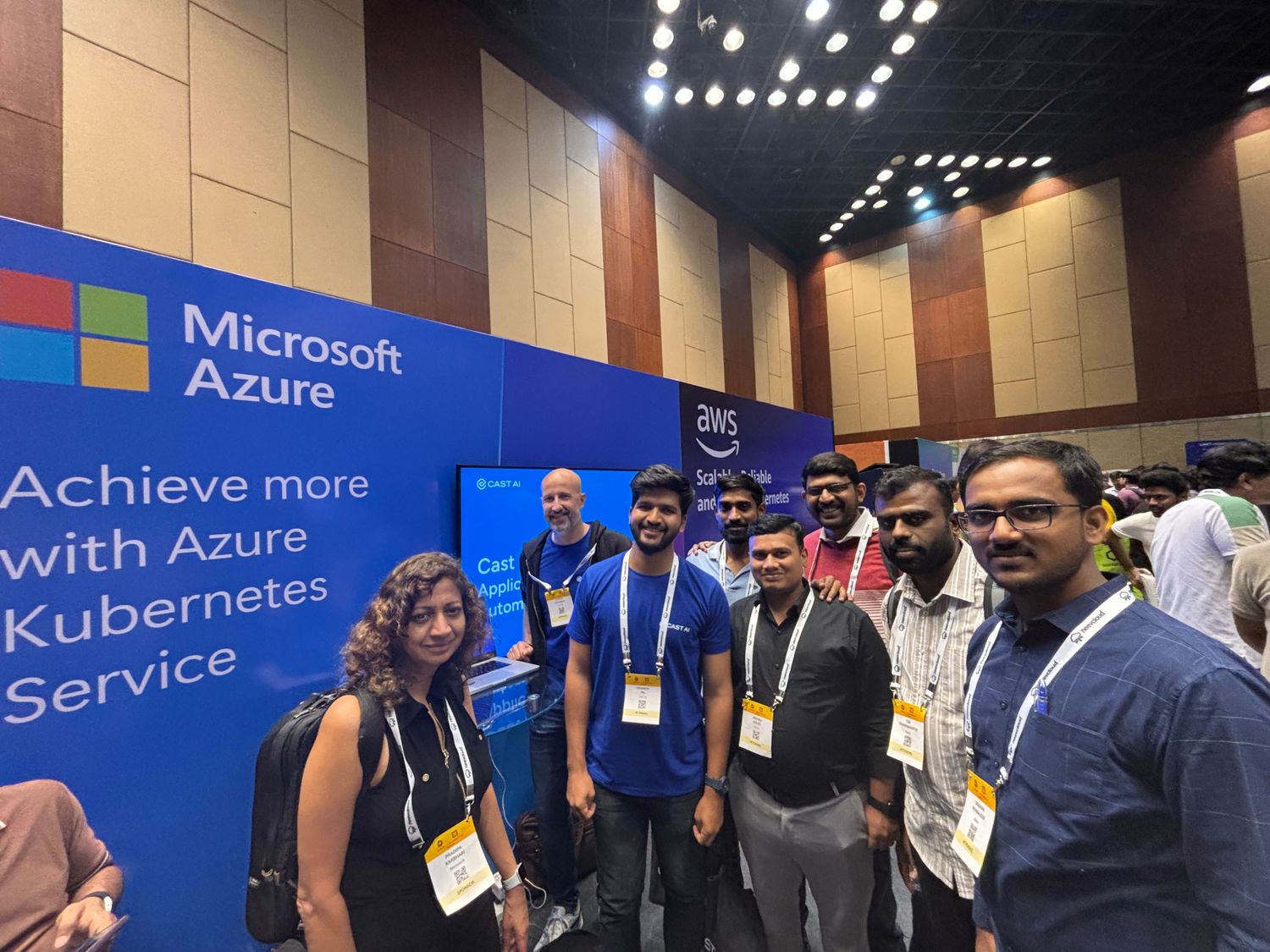 Conference attendees networking at a Microsoft Azure booth with blue banners and signage.