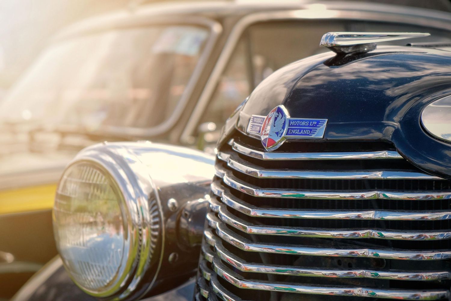 Close-up details of classic car chrome grilles and headlights in vintage style.