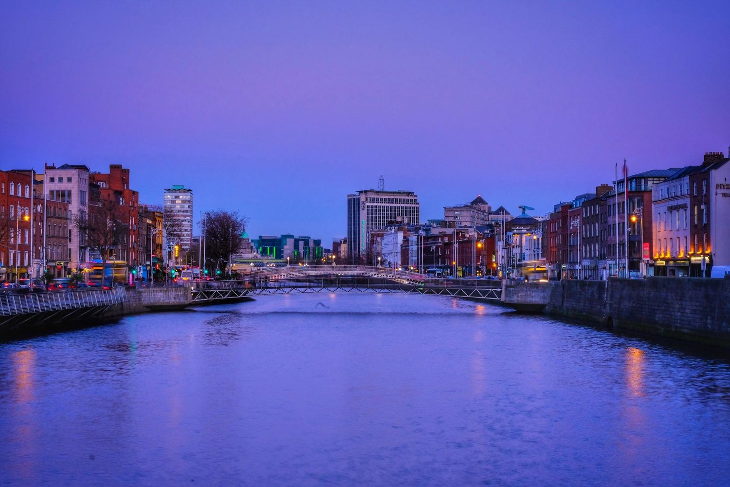 Purple twilight panorama of Venice canals with historic buildings and waterways.