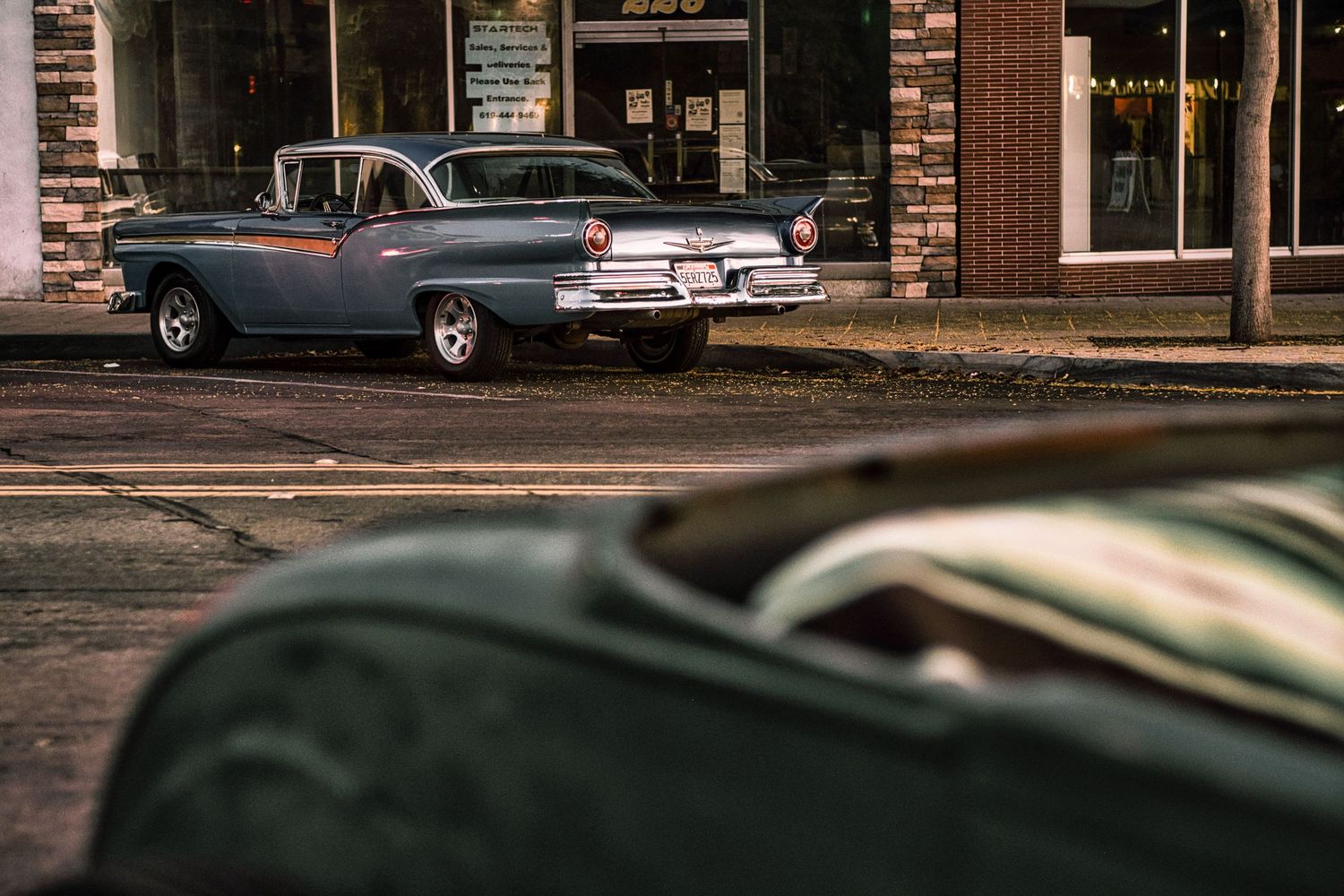 Classic vintage cars lined up at a car show displaying their sleek retro designs and chrome details.