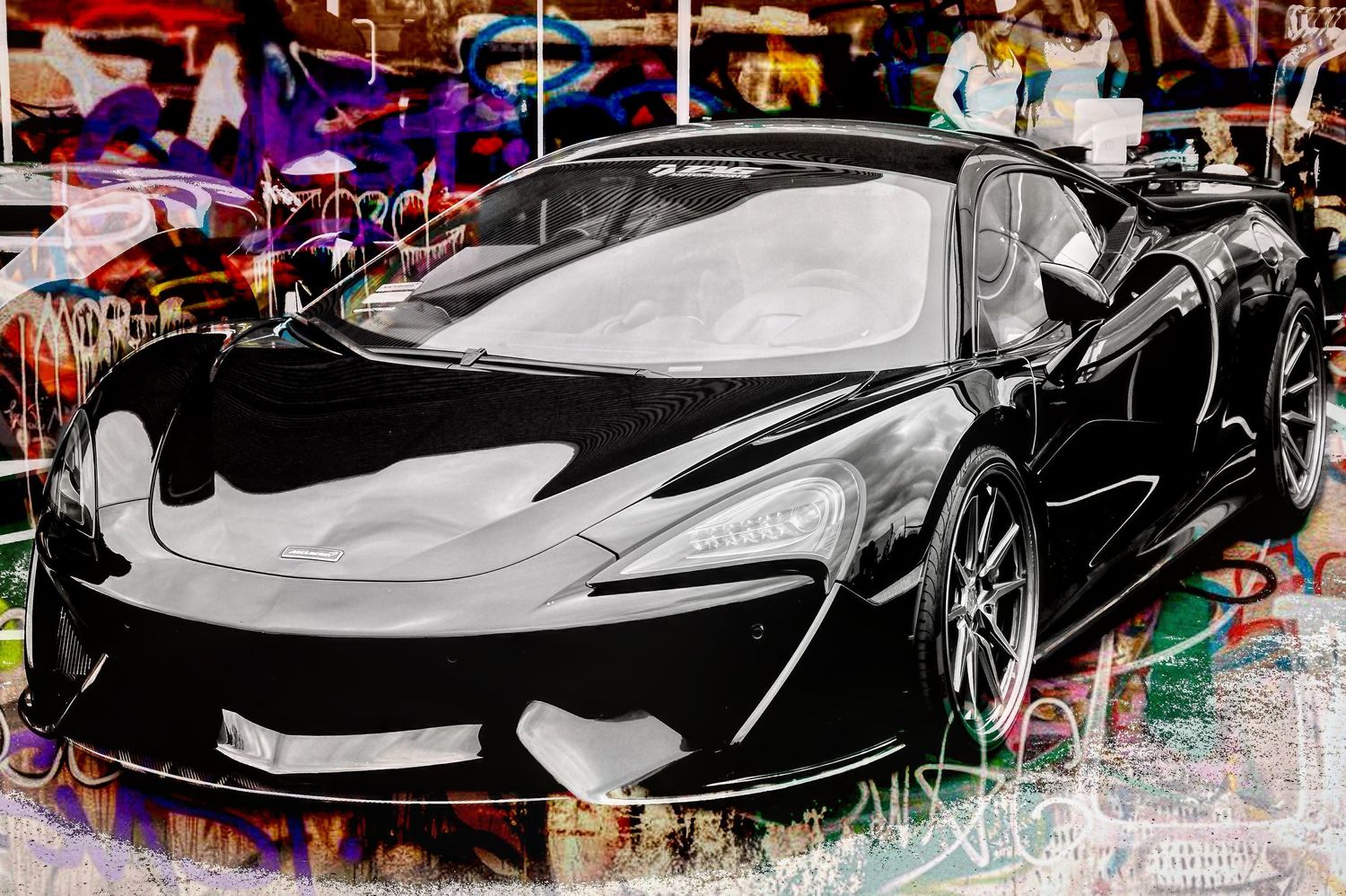 High-contrast artistic photo of luxury supercars with graffiti-style background effects.