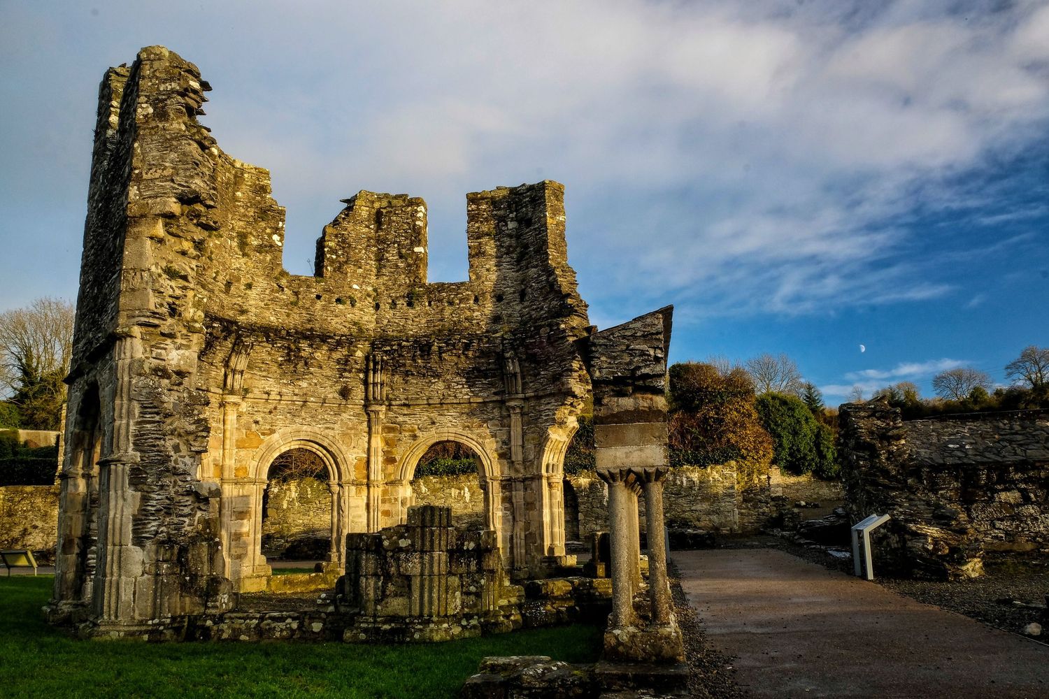 Ancient stone ruins of a historic abbey or church under blue sky.