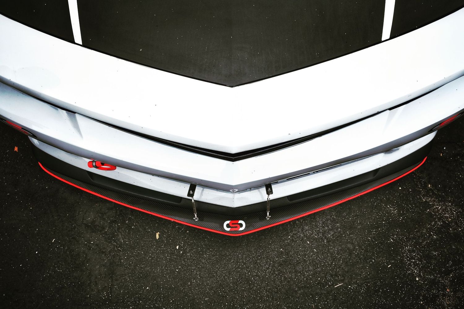 Close-up detail of white car front bumper and grille design.