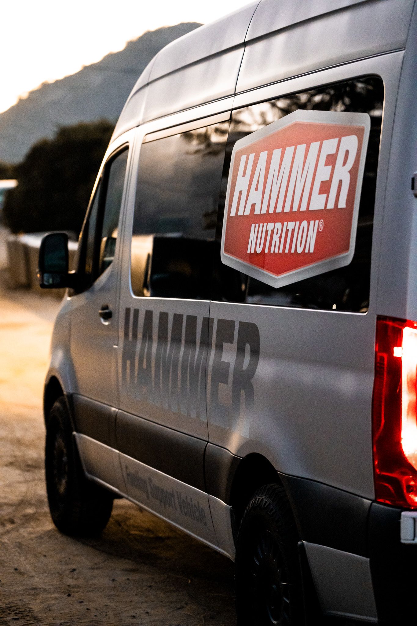 Grey Hammer Nutrition branded delivery van photographed at sunset.