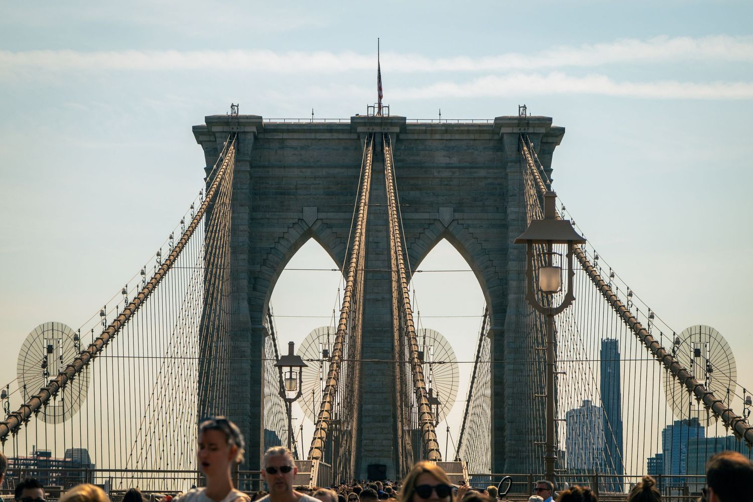 Panoramic view of the Brooklyn Bridge towers and cables during sunset.