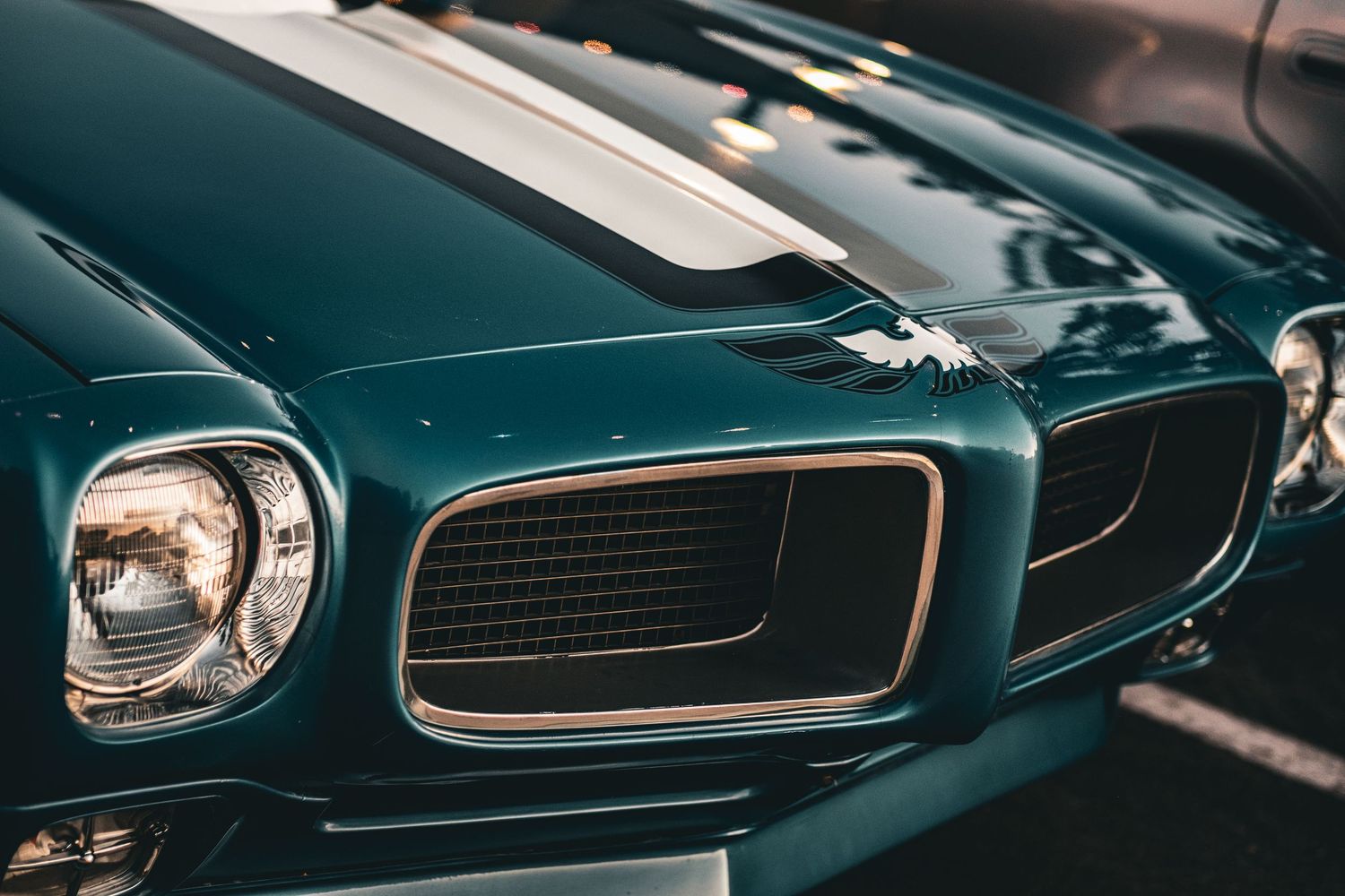 Detail shots of vintage car headlights and grilles in dramatic lighting.