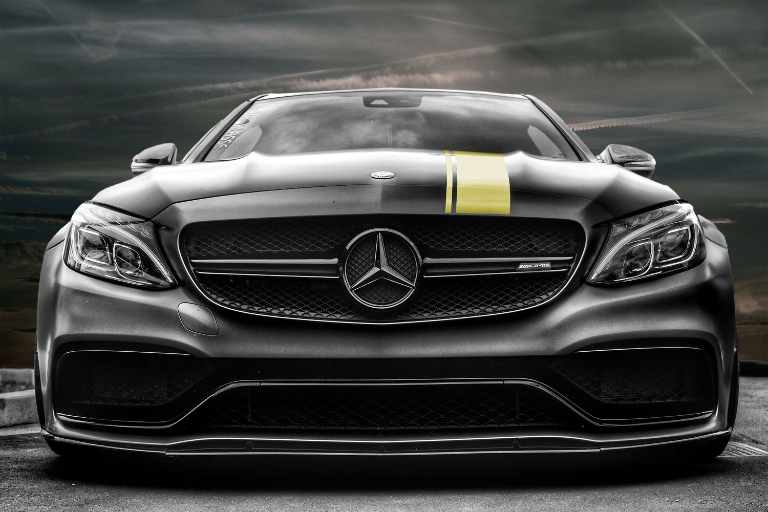 Front view of a sleek black Mercedes-Benz AMG sports car with aggressive styling.