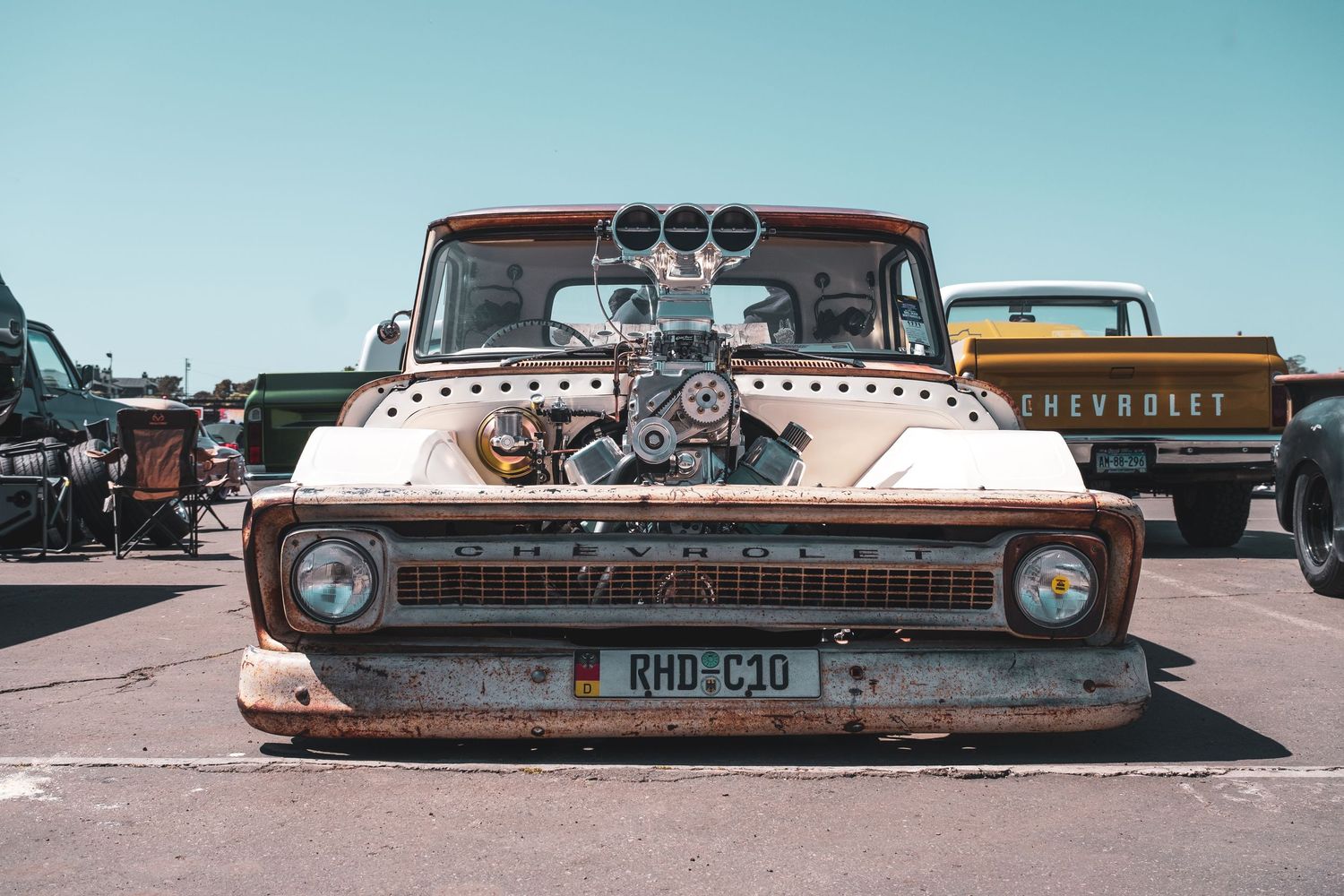 A collection of vintage Chevrolet cars and trucks displayed in a row showing various customized and modified styles.
