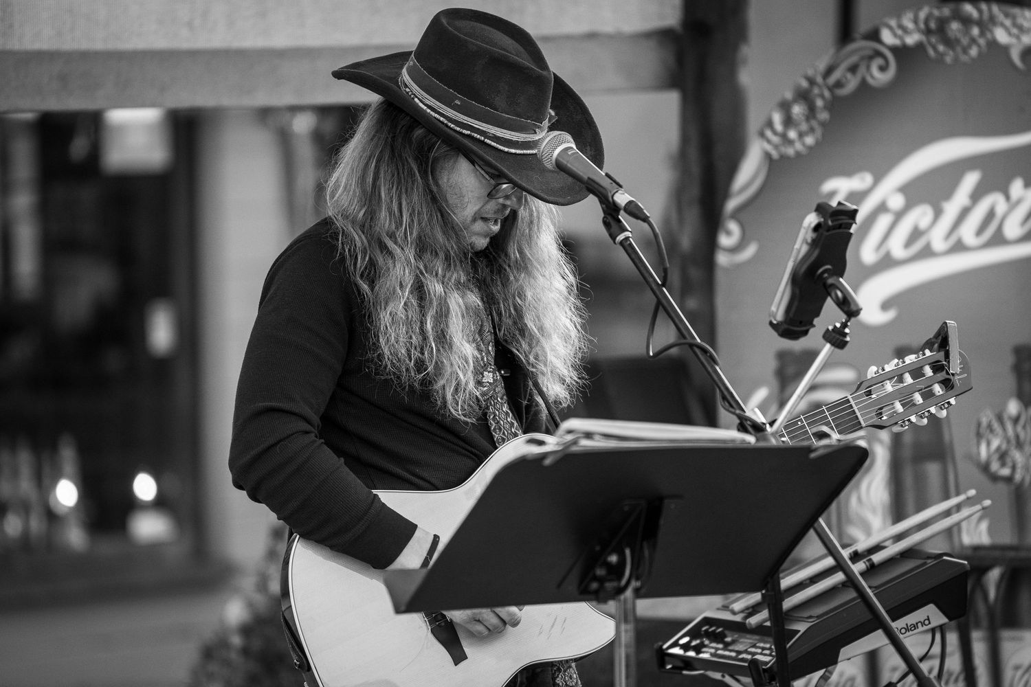 Musicians performing at an event in black and white photography.