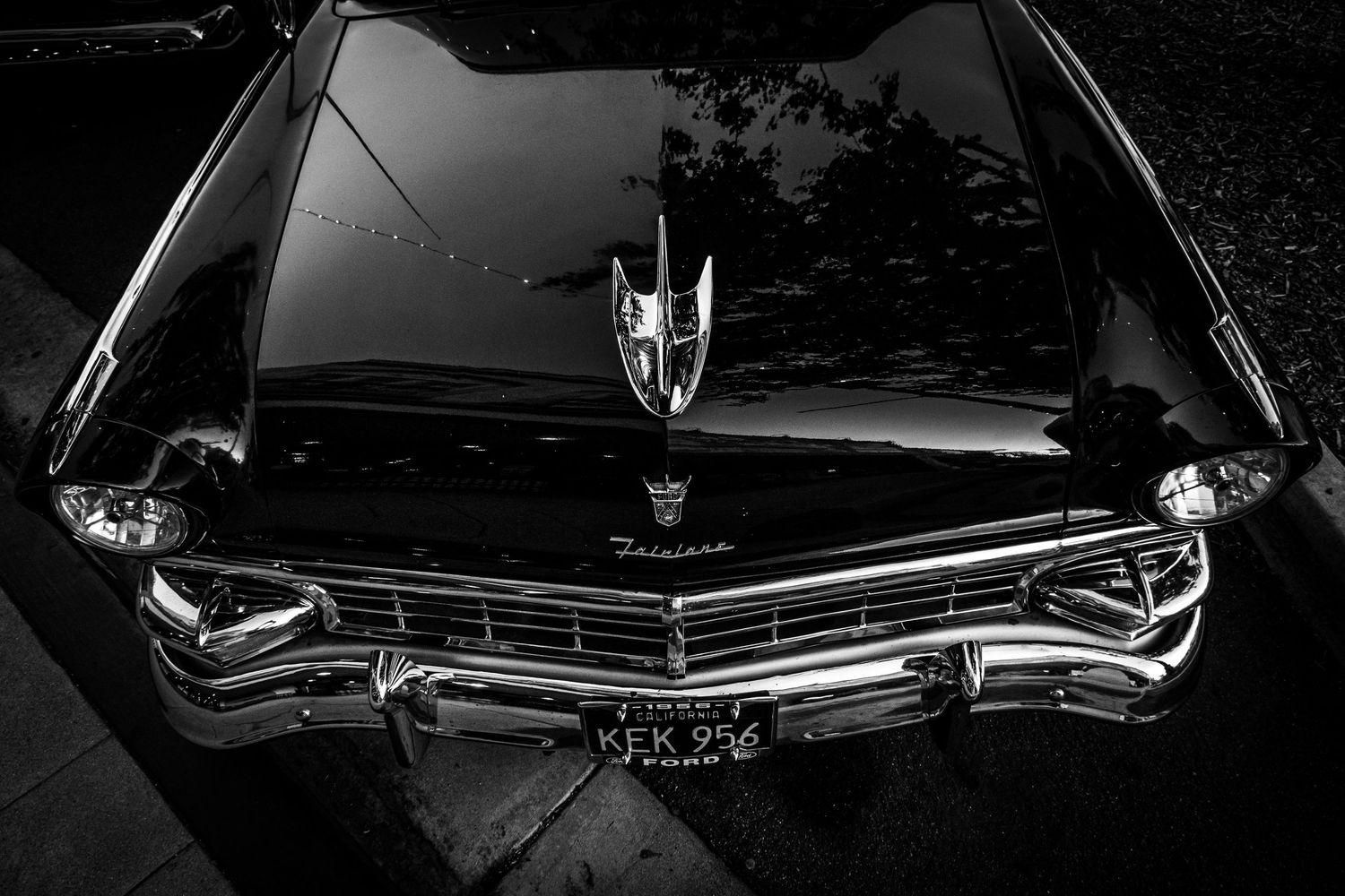Classic car silhouettes in black and white showing sleek vintage automotive design details.