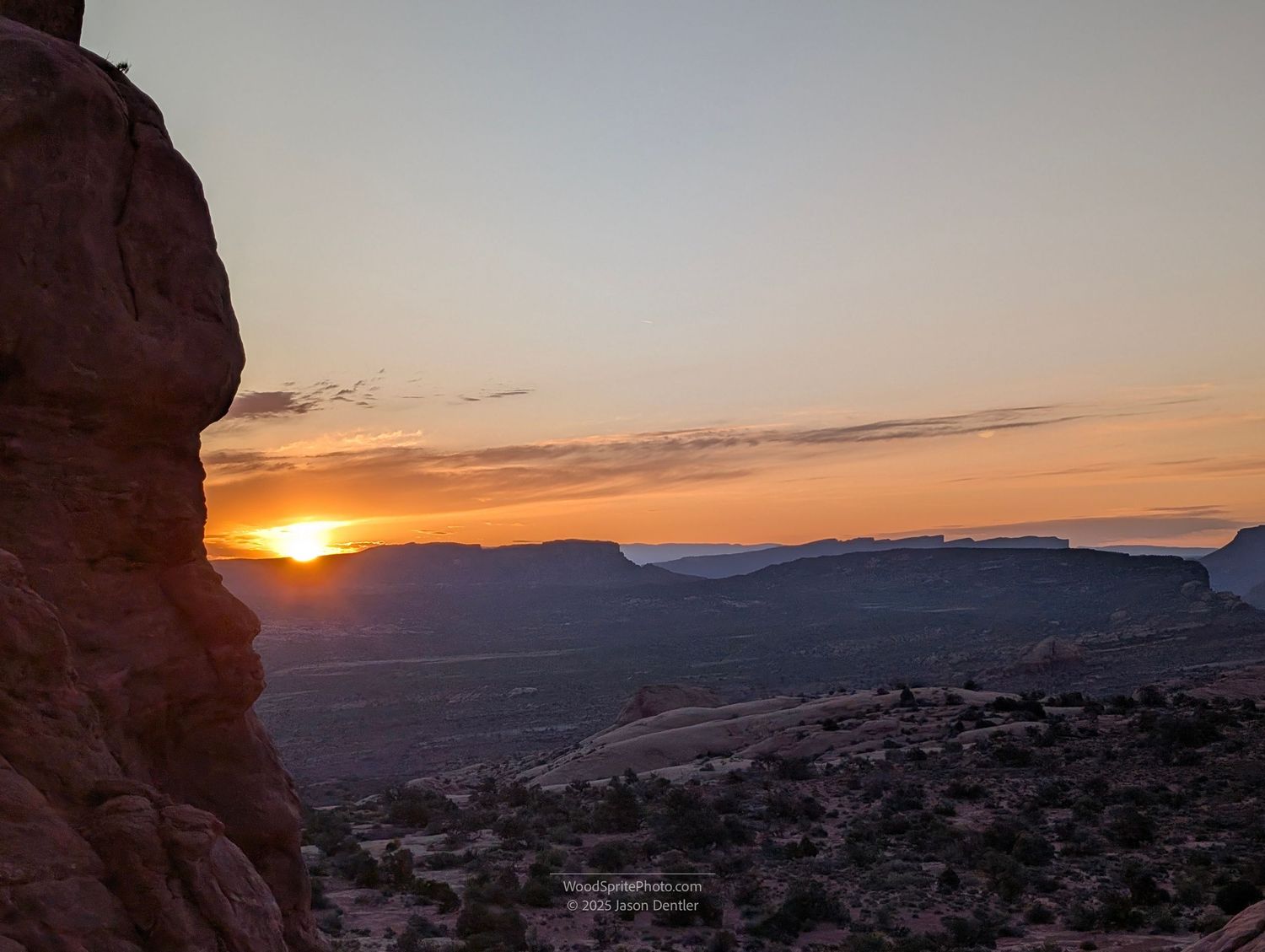 Sunrise view through sandstone rock formation in Arches National Park, Utah.