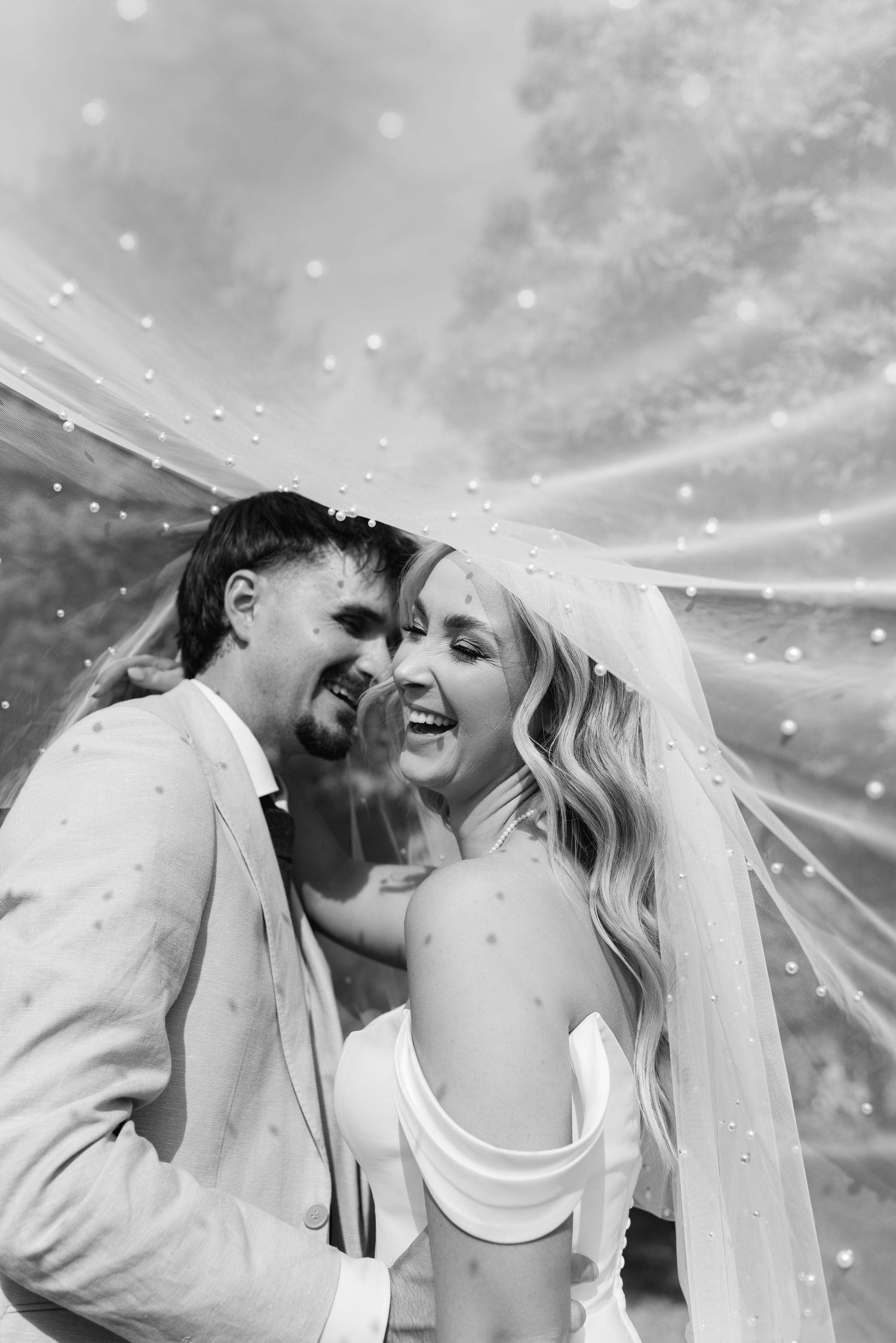 A romantic black and white wedding photo sequence showing tender moments between newlyweds with a flowing veil.