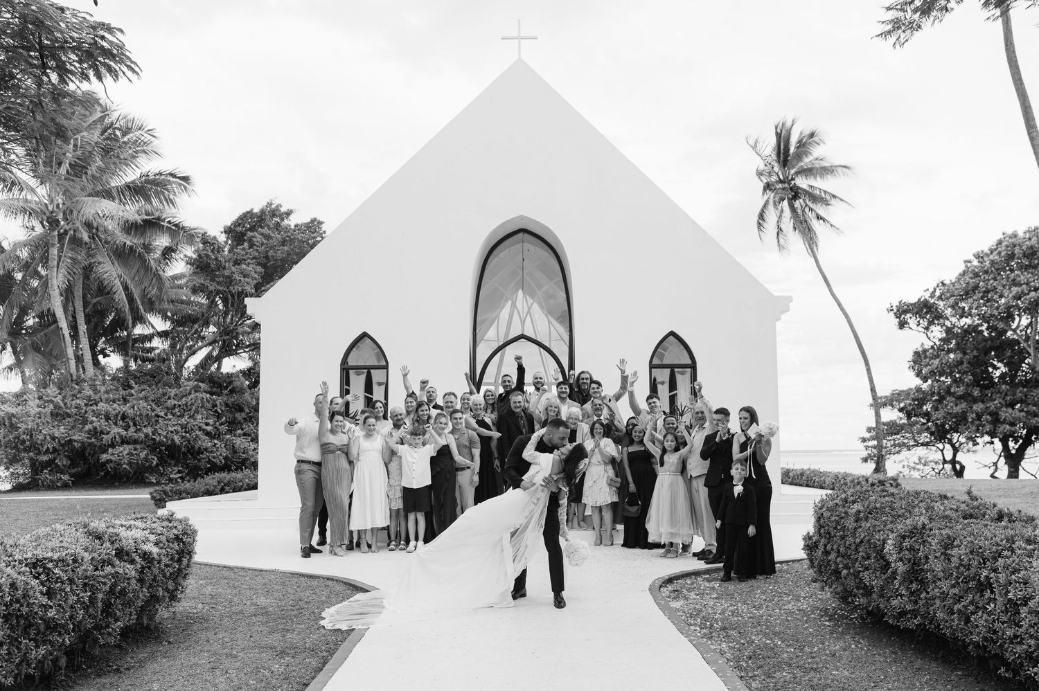A series of black and white wedding ceremony photos showing couples and guests at a traditional church venue in Hawaii.