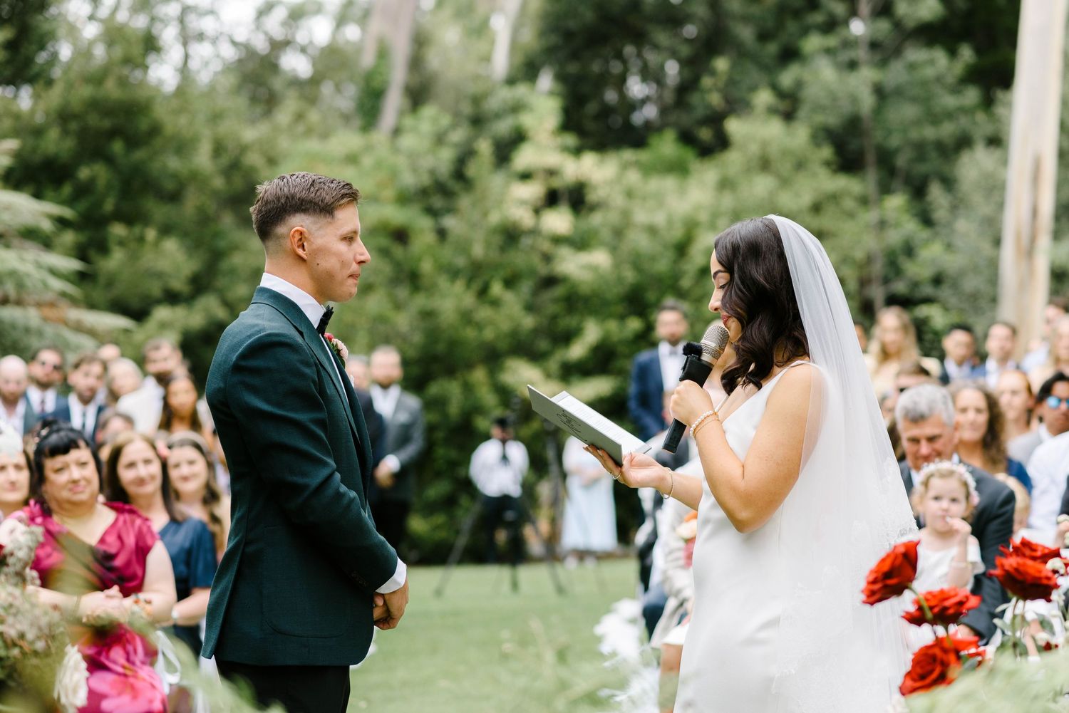 A series of candid wedding moments captured outdoors showing dancing, embraces and celebration in a garden setting.
