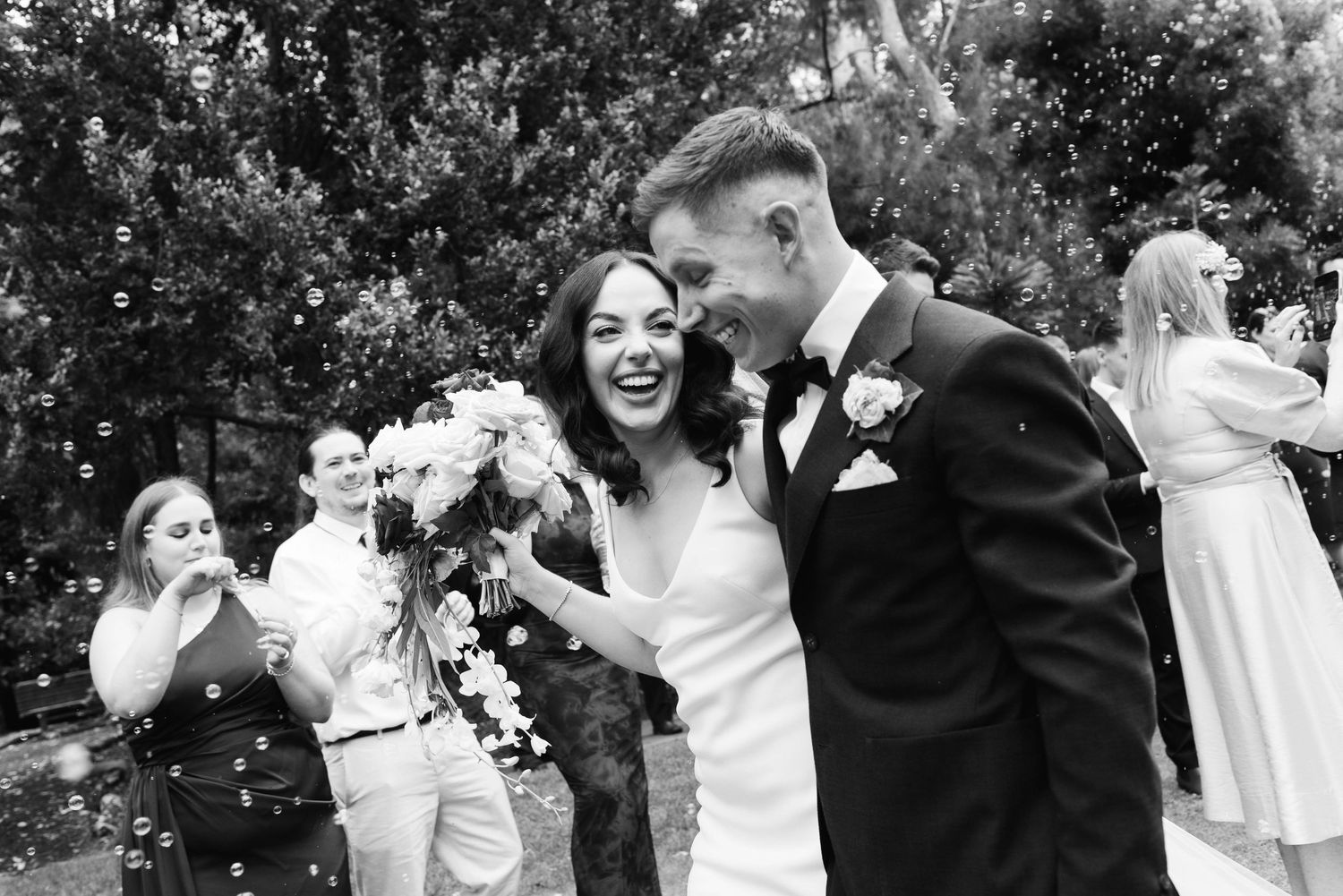A series of candid black and white wedding photos showing joyful moments and laughter during an outdoor celebration.