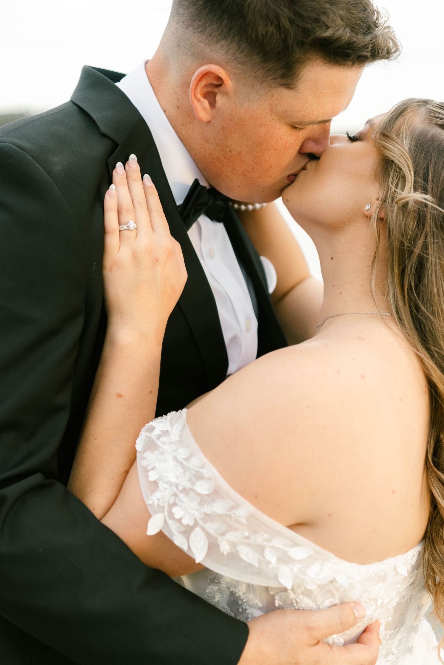 A romantic wedding couple sharing intimate kisses in a series of close-up shots showing elegant formal attire.