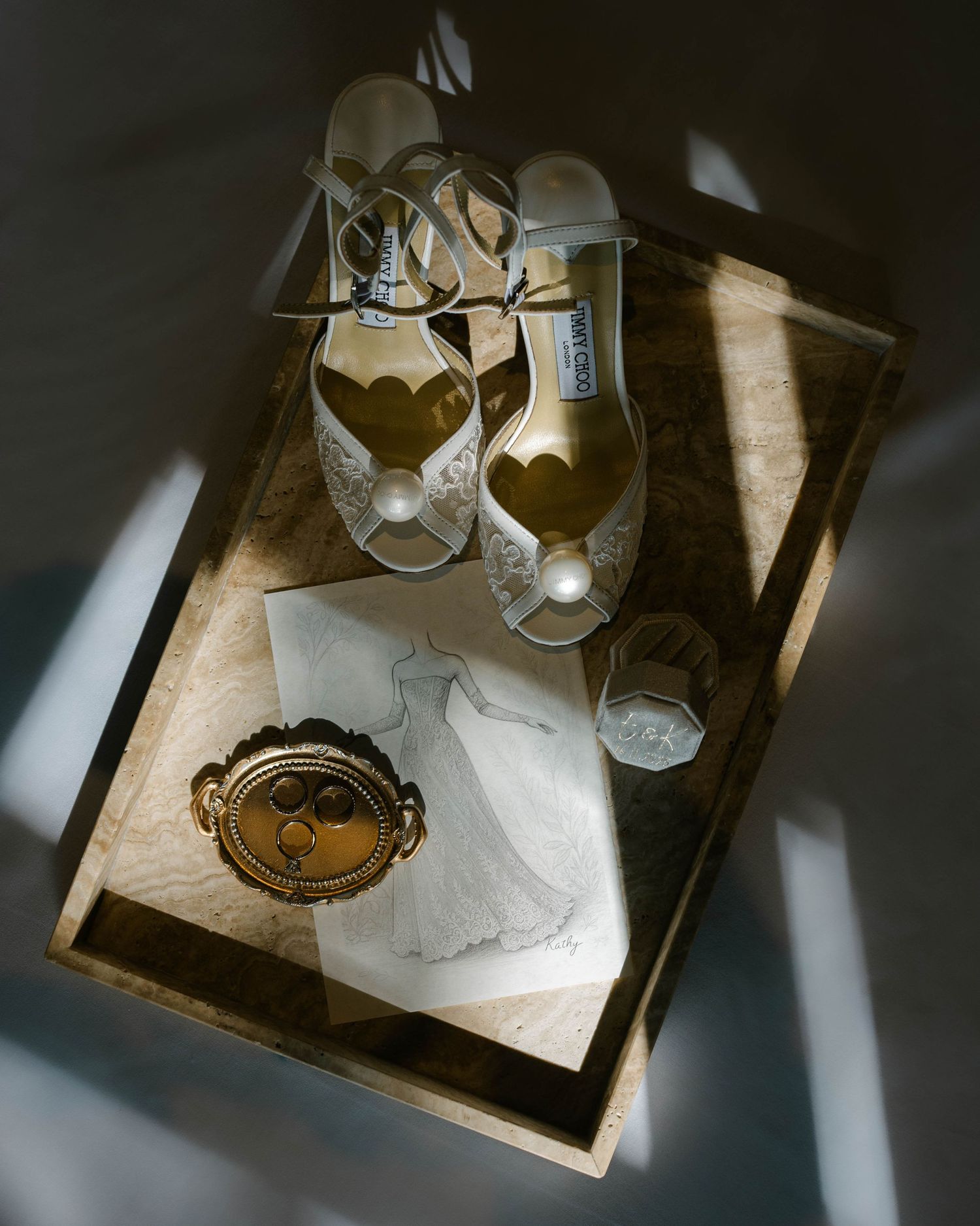 Dramatic overhead view of wine glasses casting shadows on a light marble surface in moody lighting.