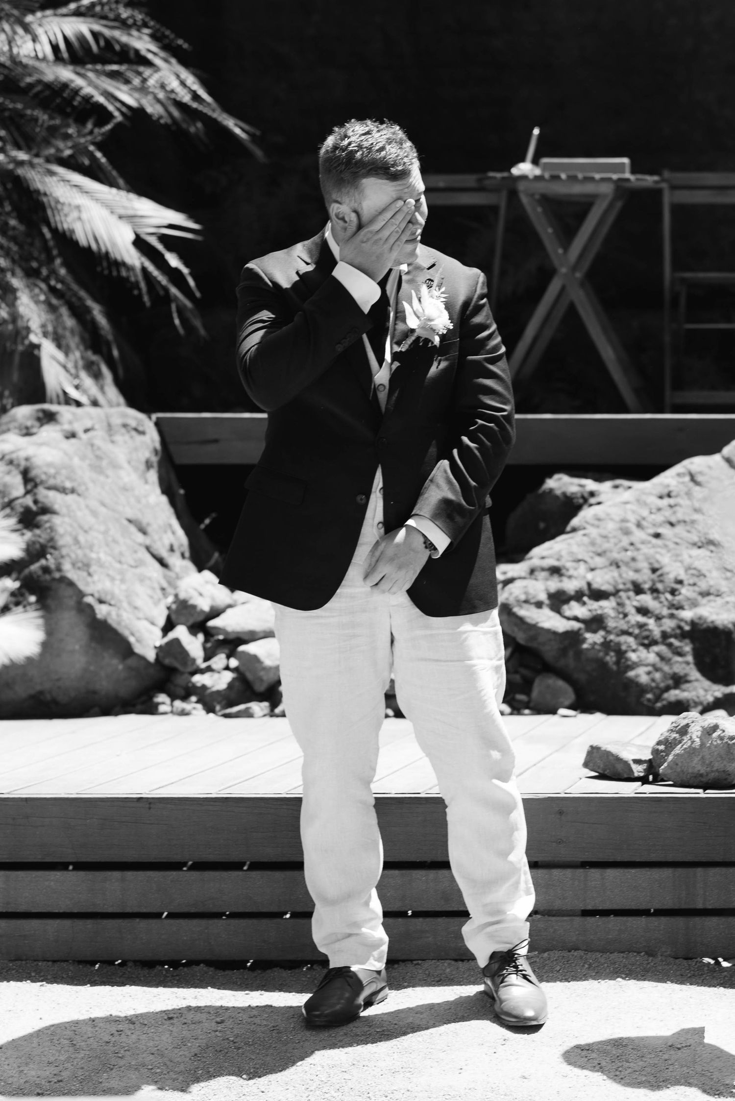 Black and white image series showing legs in white pants and dark shoes walking on a wooden deck in sunlight.