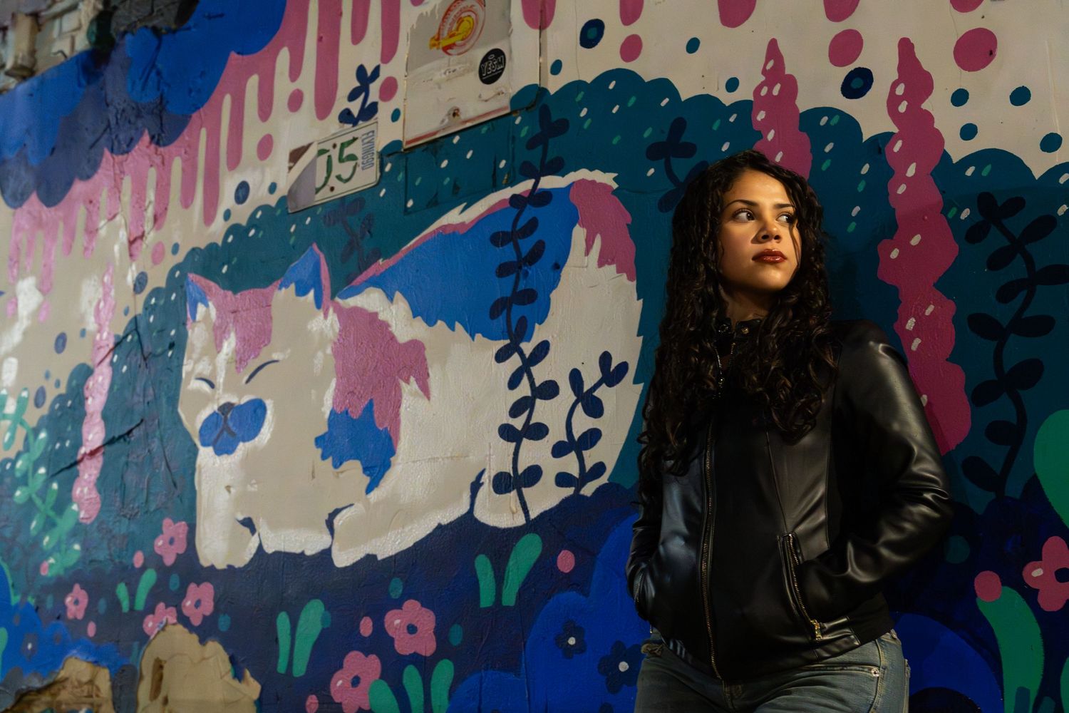 Vibrant mural wall featuring abstract splashes of blue, pink and green paint.