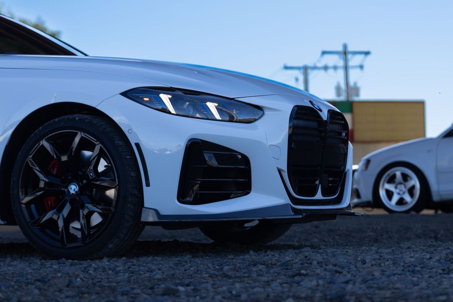 Modern luxury sports cars photographed from low angle against blue sky.