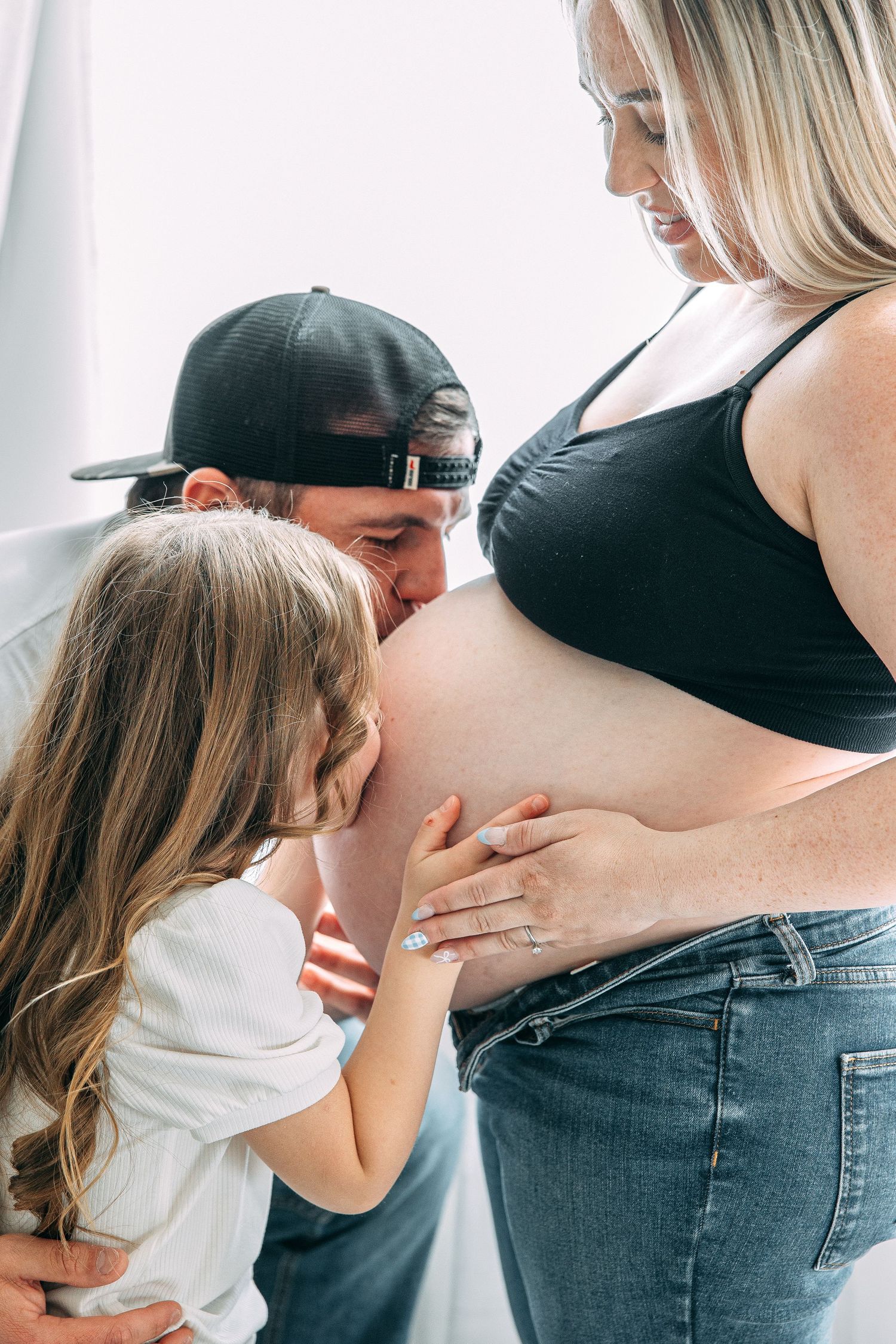 Sweet family moments captured during a maternity photoshoot.