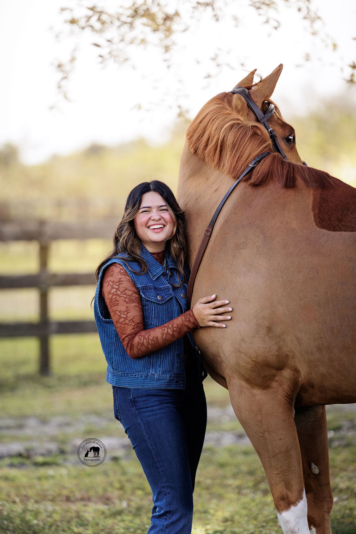 A touching moment between a horse and companion in denim overalls on a sunny autumn day.