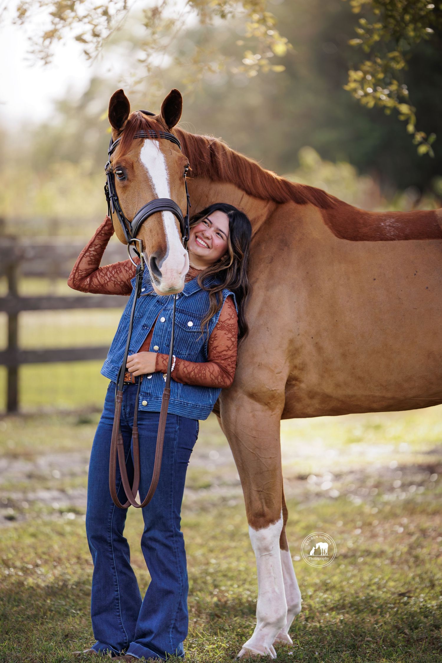 A heartwarming interaction between a horse and someone wearing denim overalls in a fall setting.