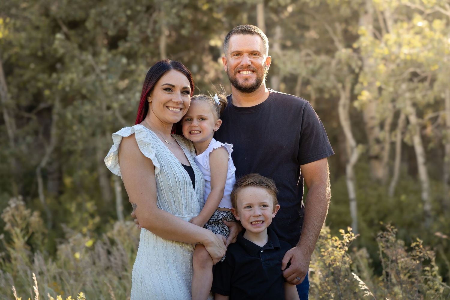 Happy family sharing joyful moments together in a natural outdoor setting.