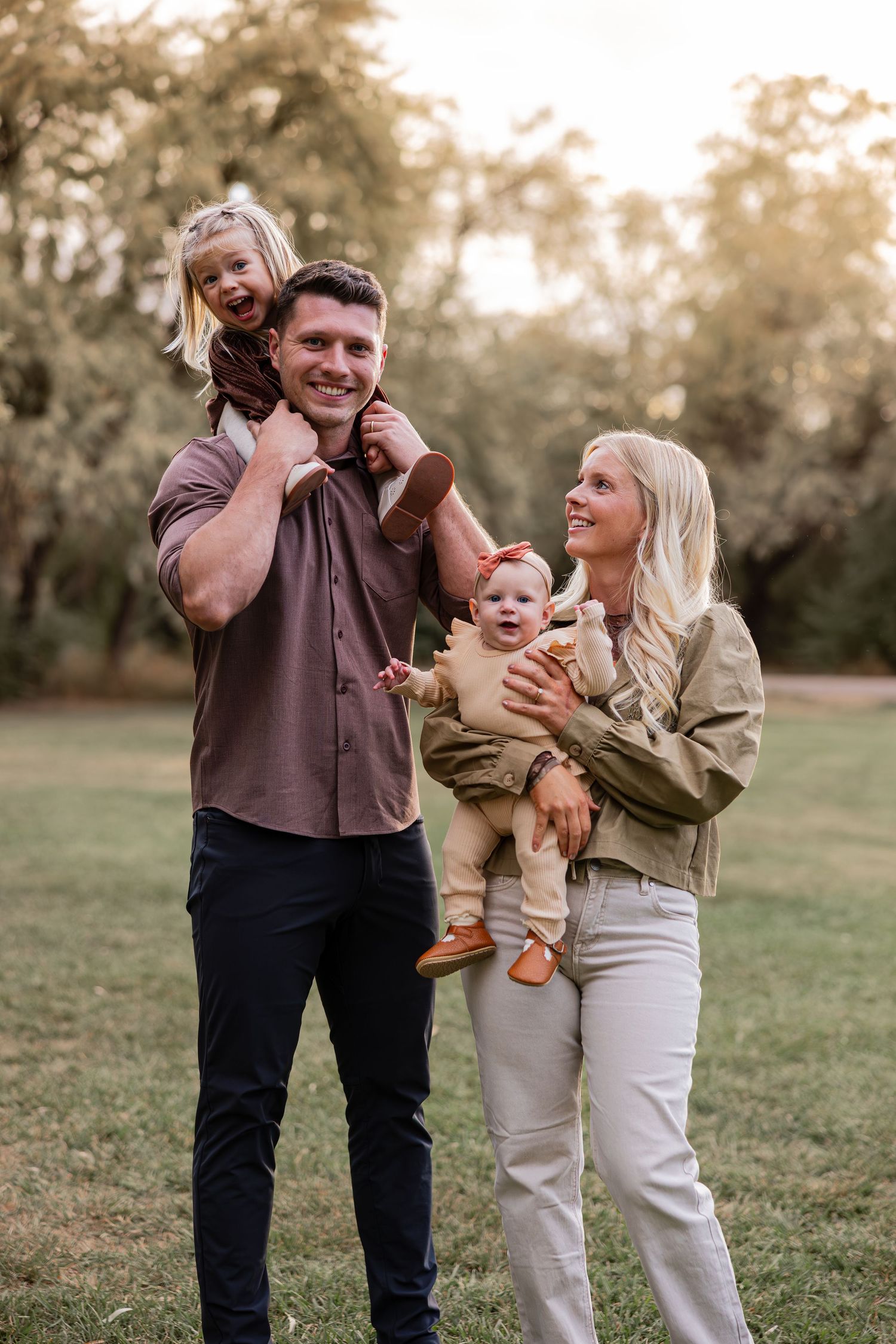 A candid family moment captured outdoors during golden hour.