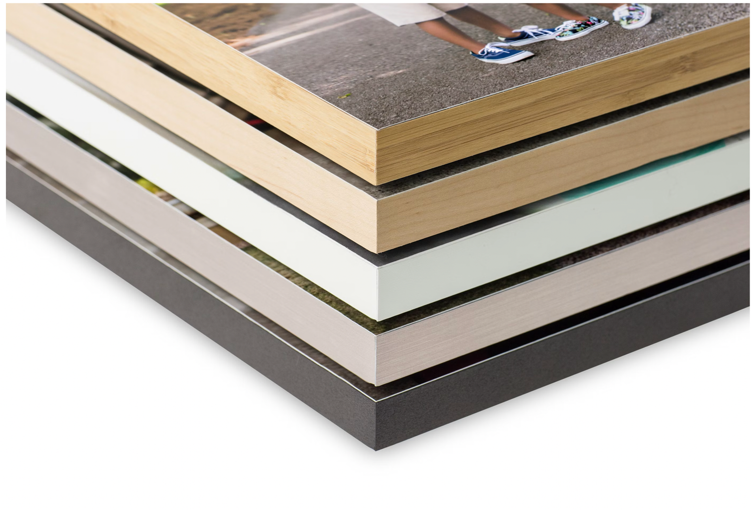 Stack of picture frames with different colored borders and matting showing layered corner detail.