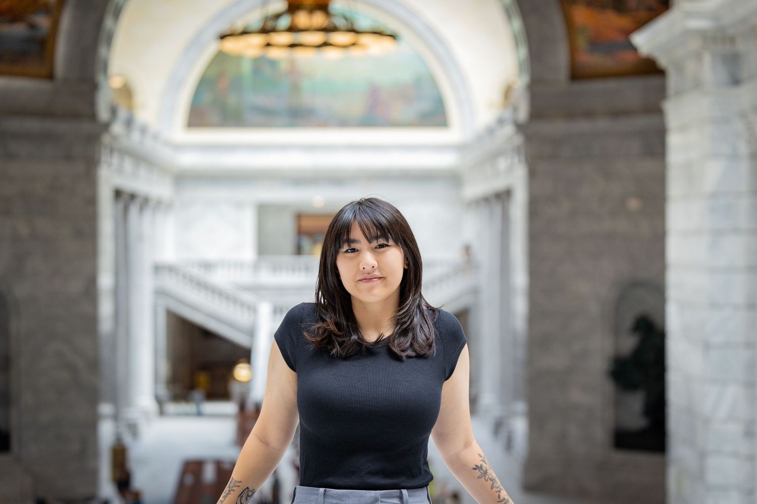 Professional portrait session featuring business attire against an elegant marble staircase background.
