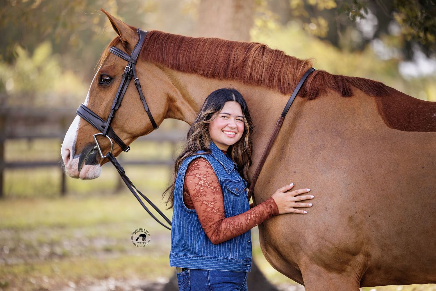 Sweet interaction between a horse and someone in denim overalls against a pastoral backdrop.