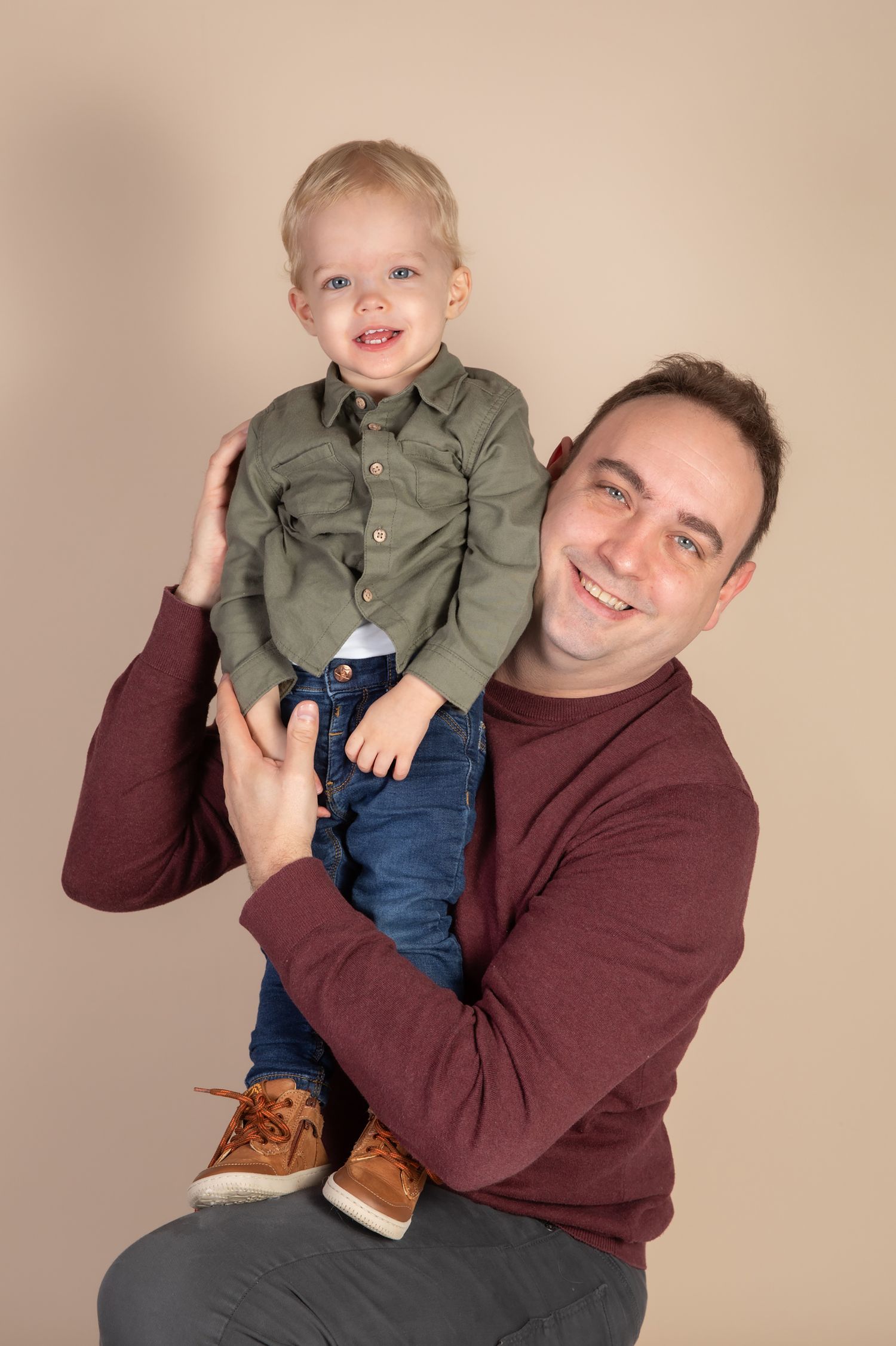 Joyful indoor portrait session showing playful moments and warm expressions.