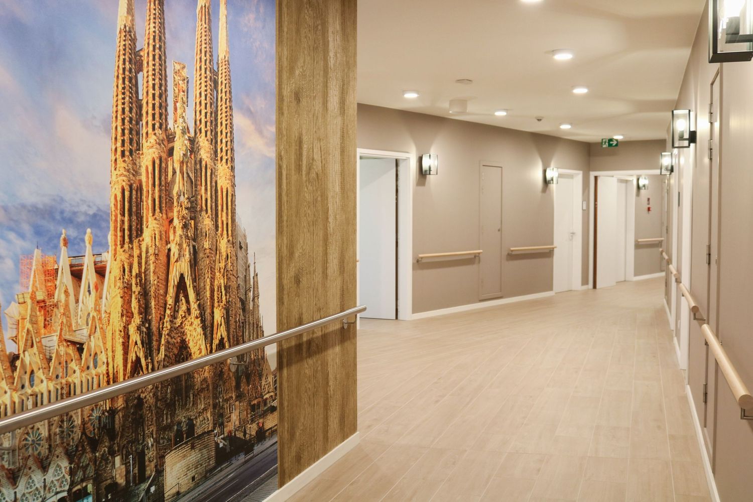 Long corridor with gothic architecture and cathedral spires visible through windows.