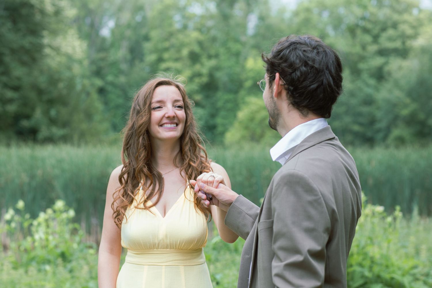 A couple sharing joyful moments in a sunny garden setting with yellow dress details.