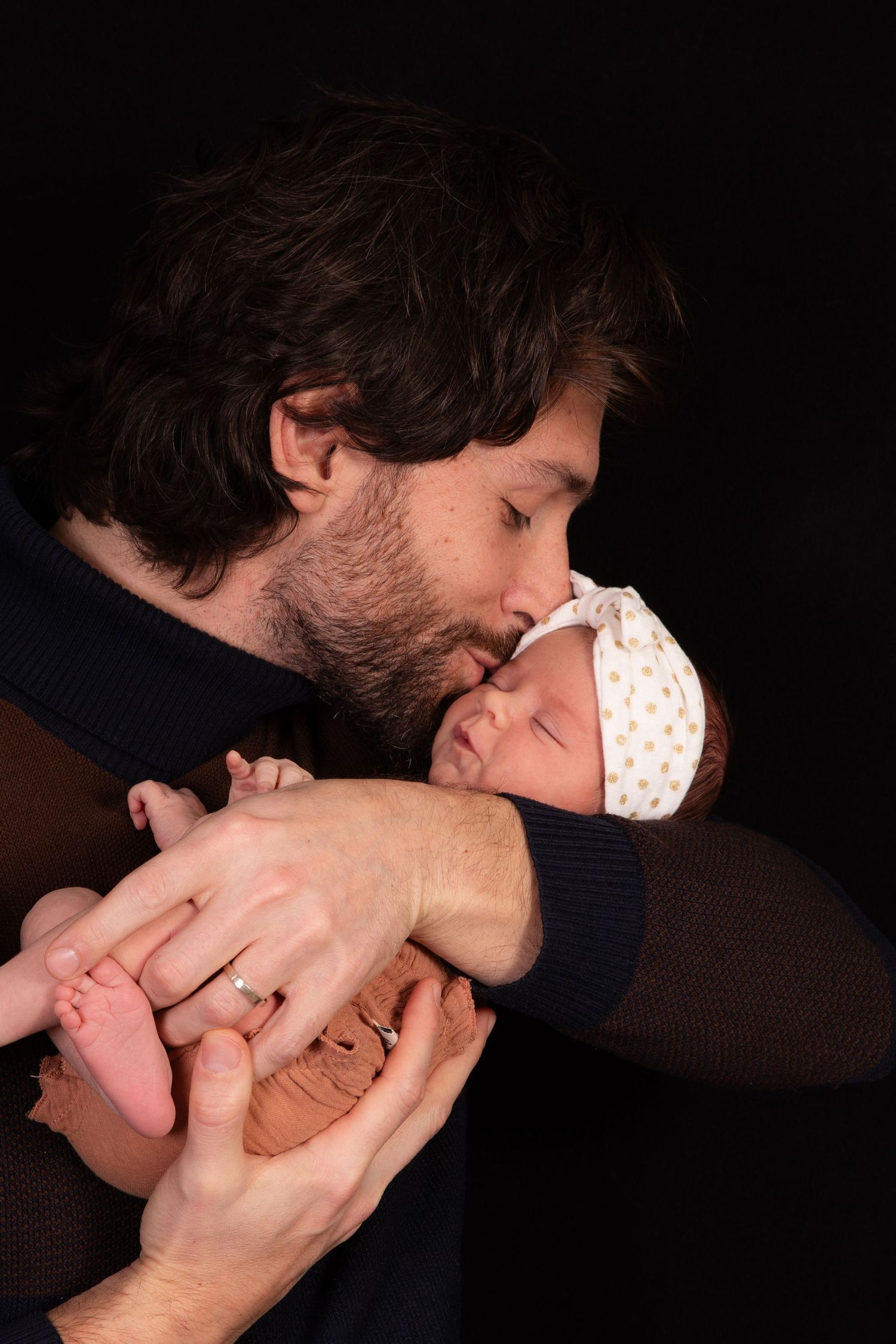 Close-up sequence of someone kissing a baby's tiny feet.