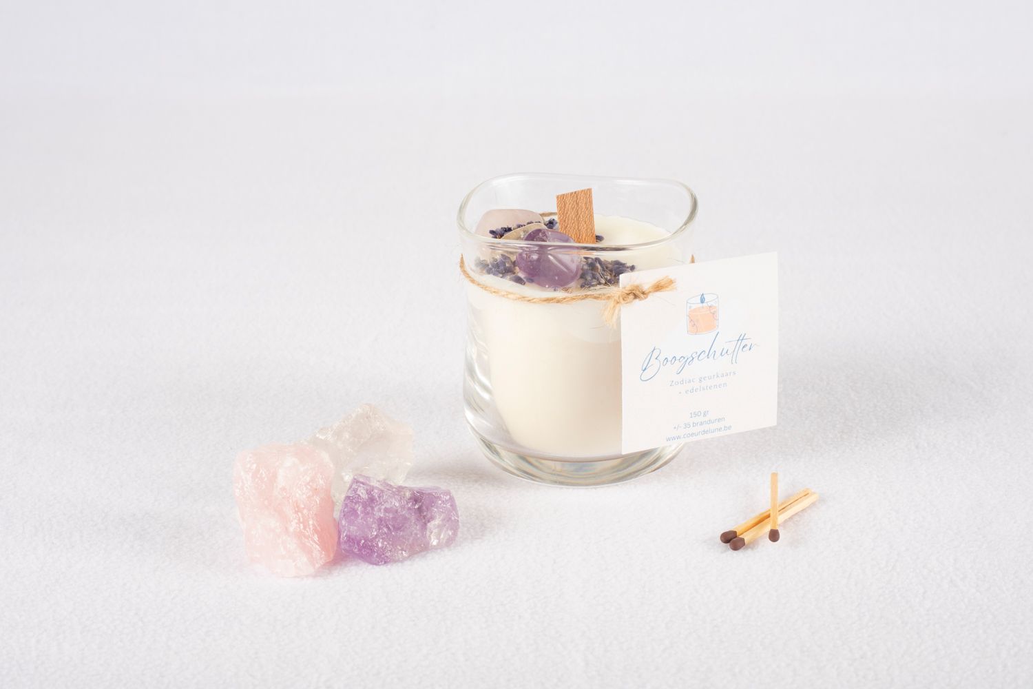 Minimalist white table setting with crystal and delicate pastel decor elements.