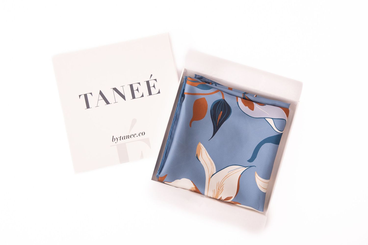 A collection of business cards and brand materials featuring abstract blue and white designs spread out on a white surface.