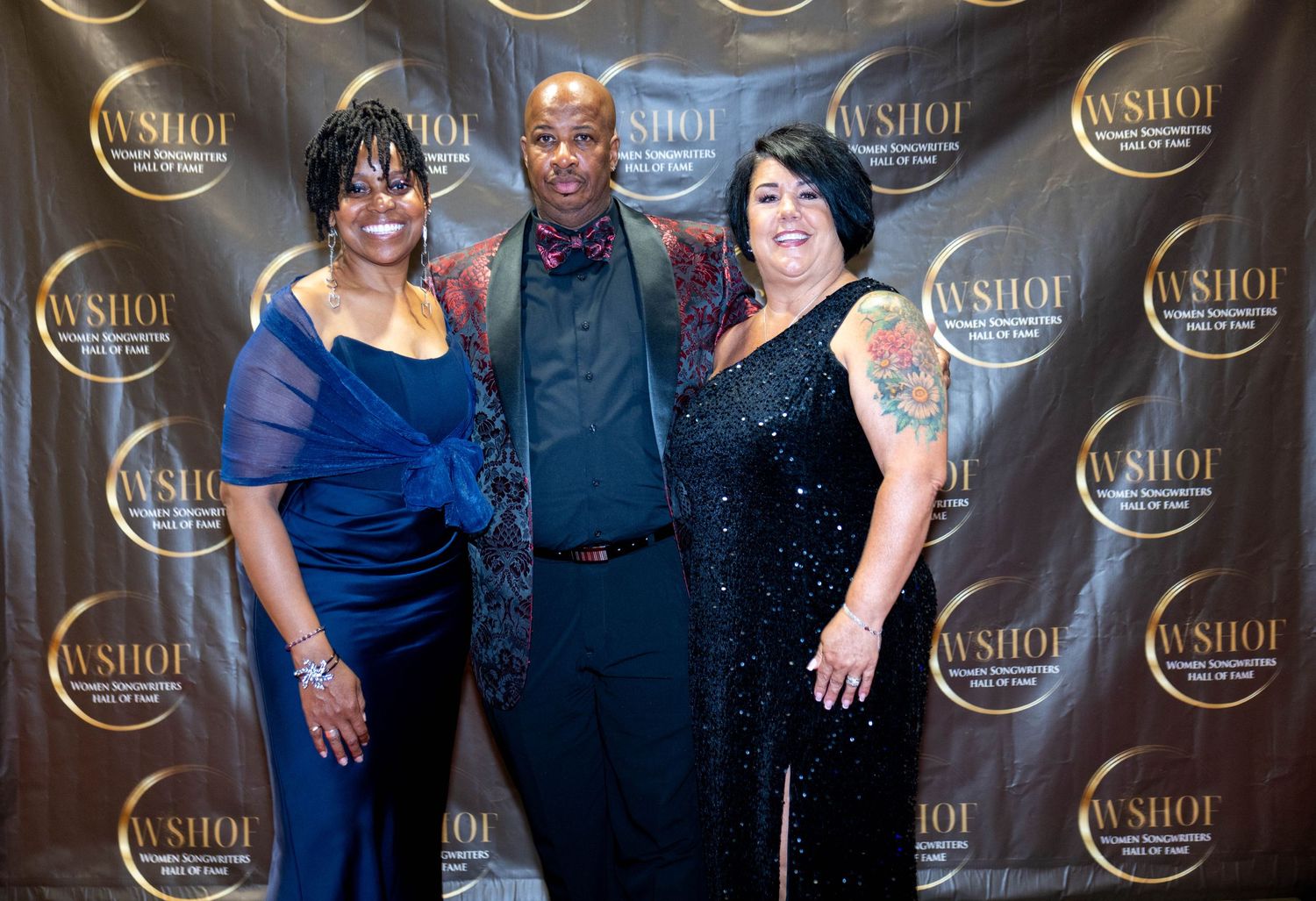 Three guests pose together at WSHOF Women Songwriters Hall of Fame red carpet event.